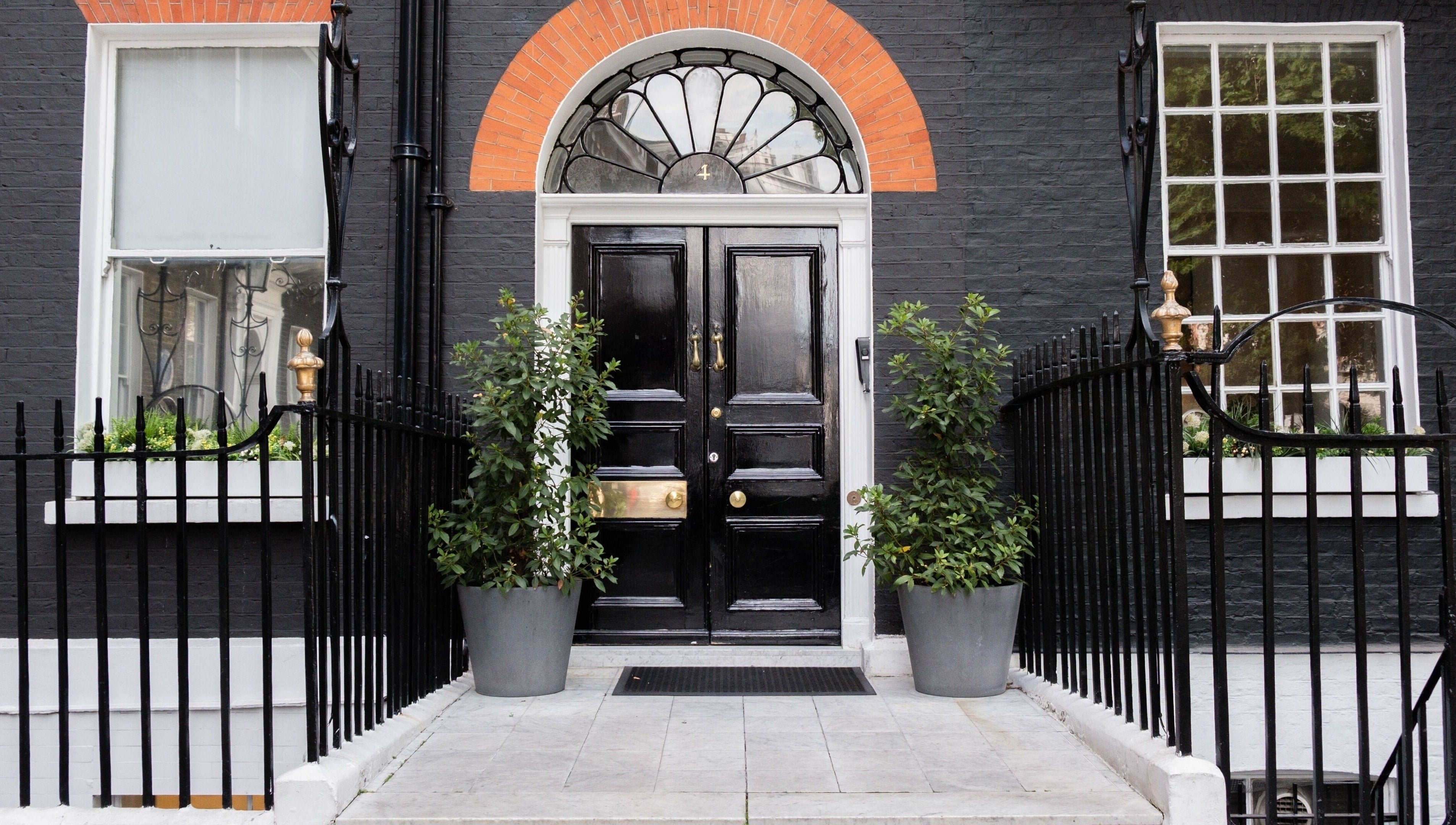 Entrance of ESPÉRER PSYCHODERMATOLOGY CLINIC in London, England, GB. Stylish black door and decorative windows.
