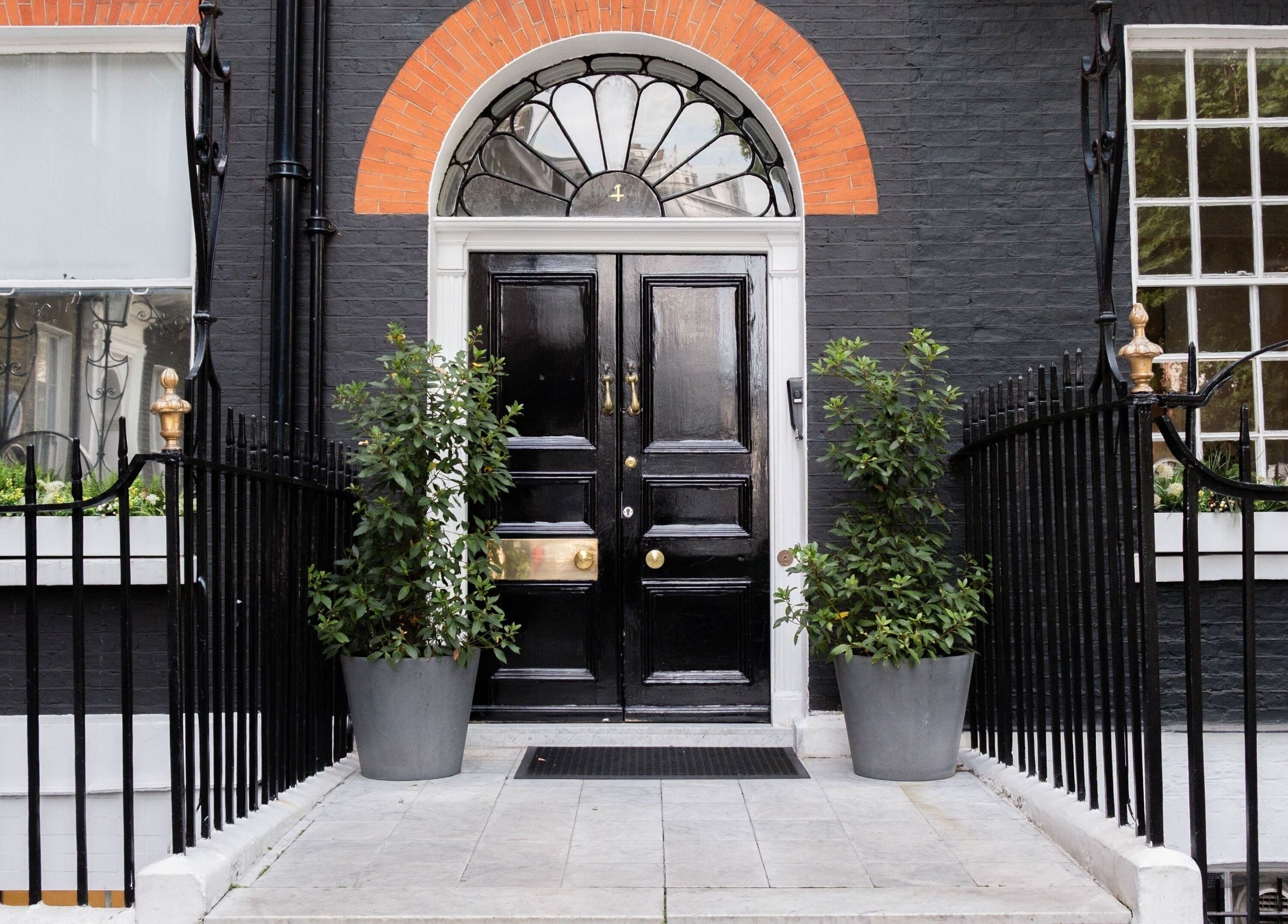 Entrance of ESPÉRER PSYCHODERMATOLOGY CLINIC in London, England, GB. Stylish black door and decorative windows.