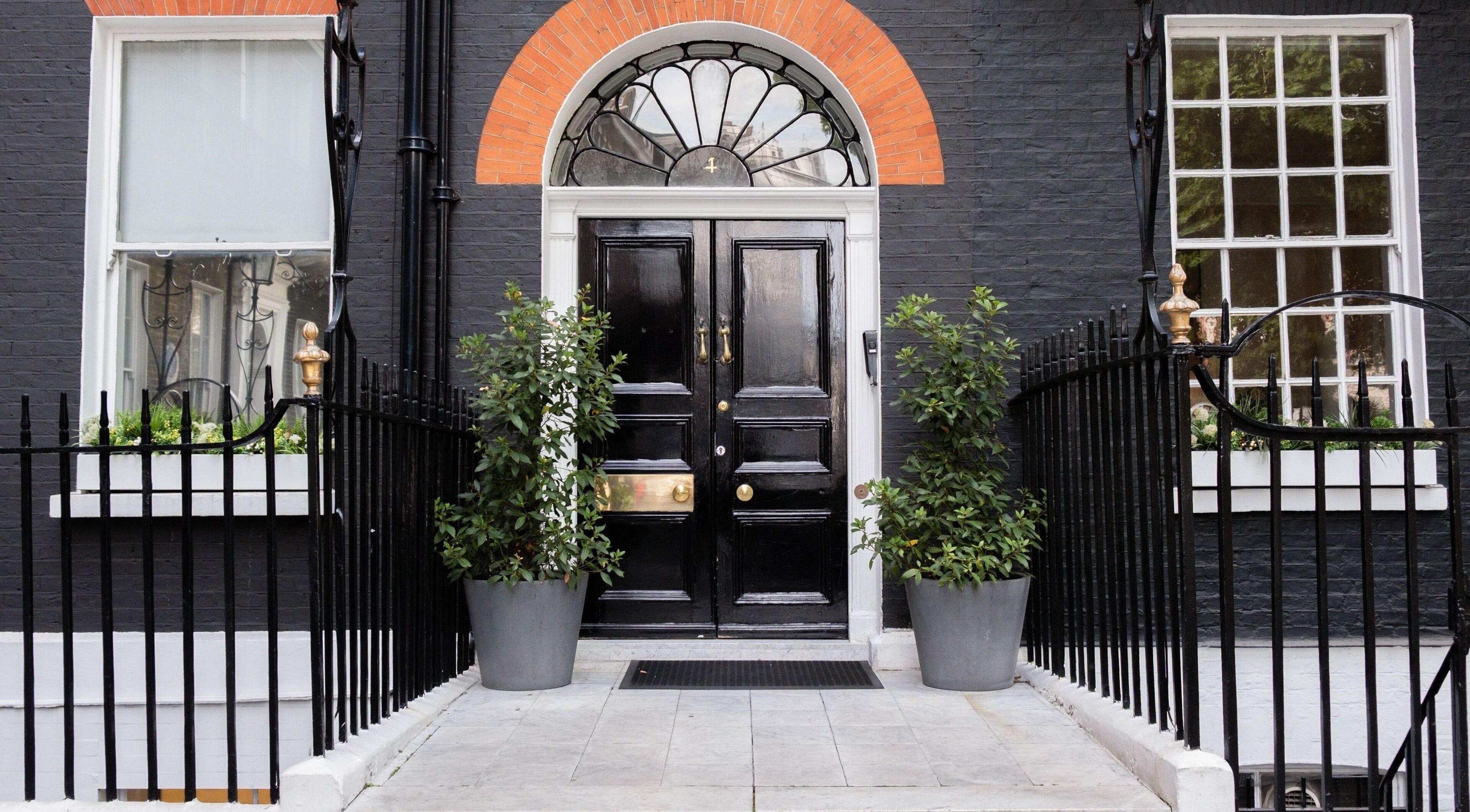 Entrance of ESPÉRER PSYCHODERMATOLOGY CLINIC in London, England, GB. Stylish black door and decorative windows.
