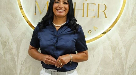 Smiling woman at ESPACO MULHER BEAUTY SPA reception in Natick, Massachusetts, US.