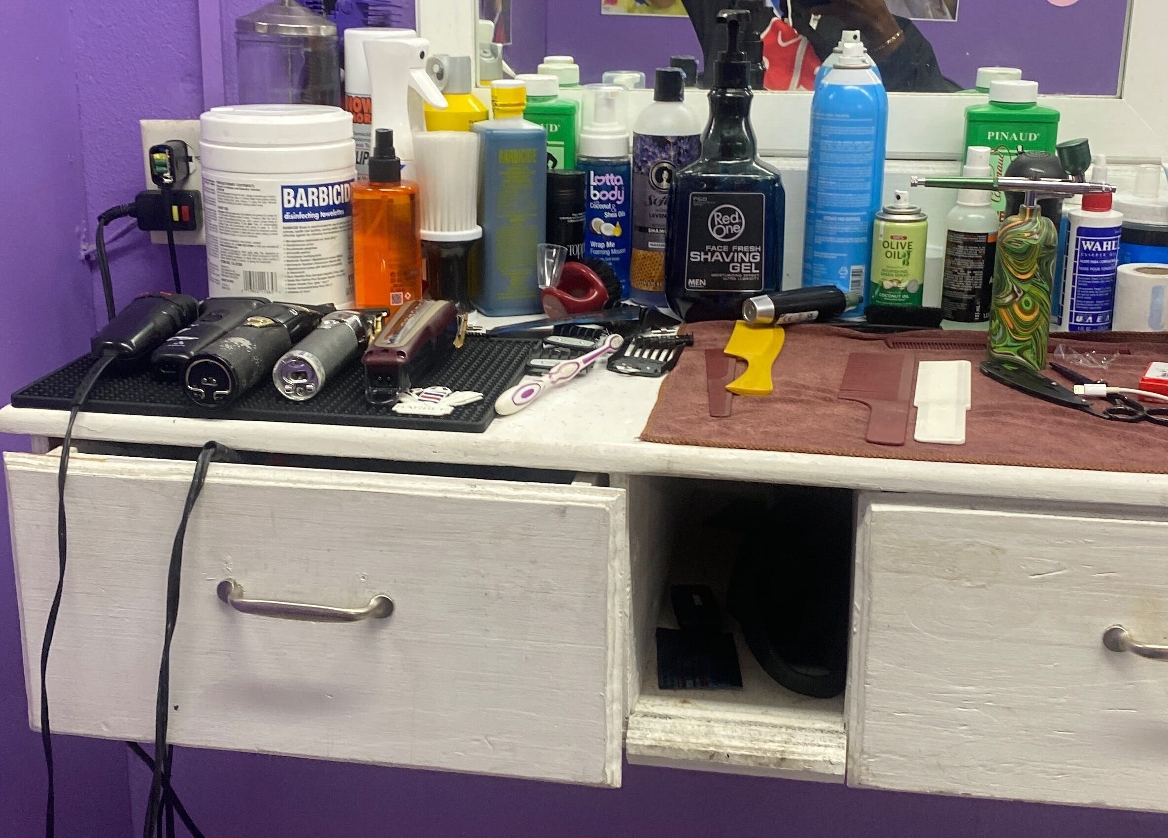 Hair styling tools and products on a counter at Dre Cool Cutz, Nassau, New Providence, BS.