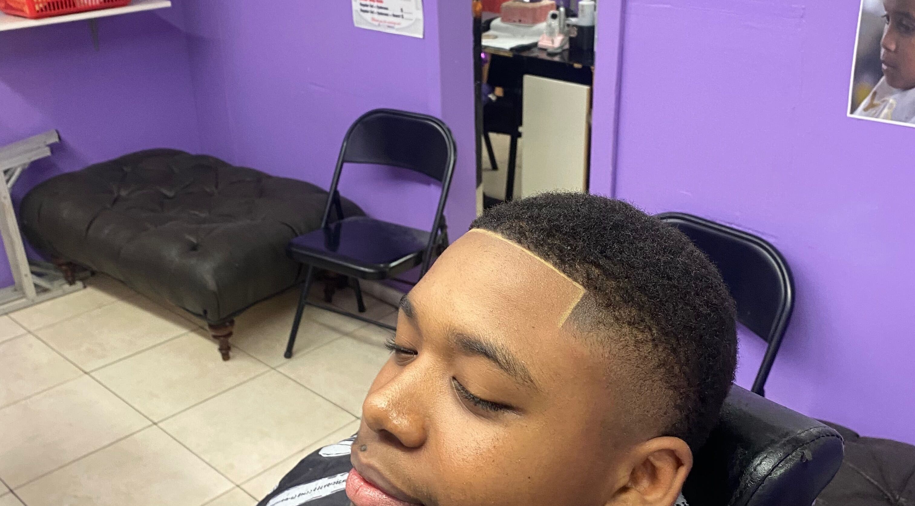 Close-up of a fresh fade haircut at Dre Cool Cutz, Nassau, New Providence, BS purple interior.