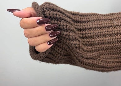 Stylish mahogany manicure at Just Beauty, Carlisle, England, GB, showcasing elegant long nails.