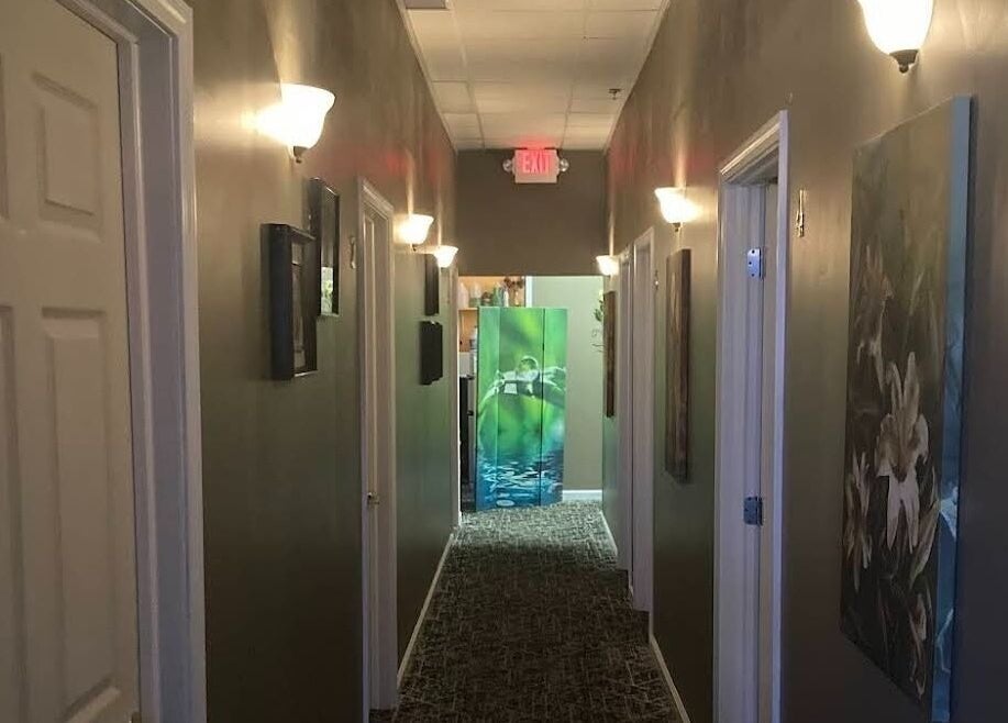 Tranquil hallway at Relax Massage, Douglasville, Georgia, US, with soft lighting and peaceful decor.