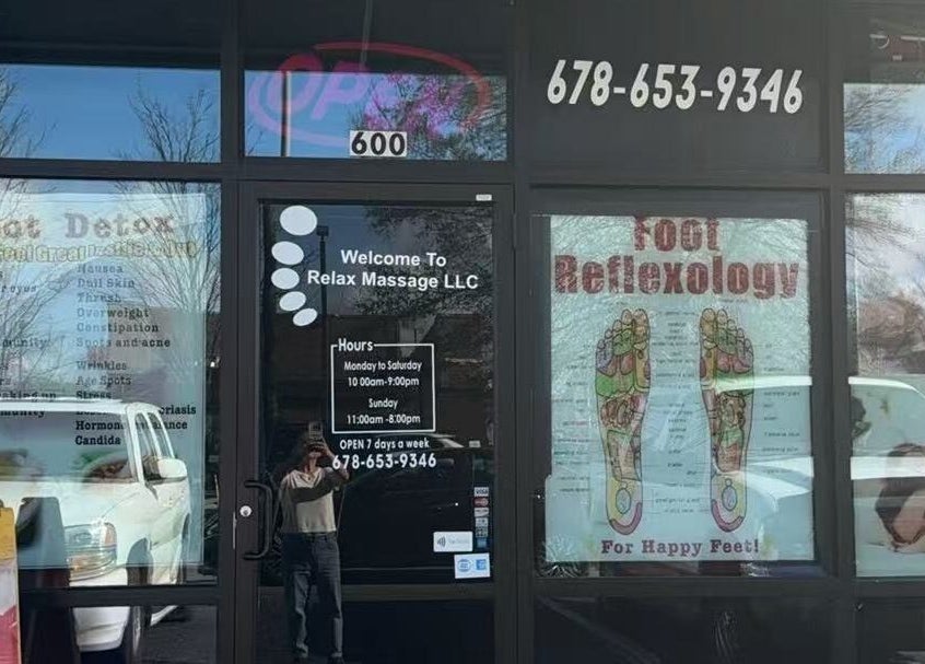Front entrance of Relax Massage in Douglasville, Georgia, US, showcasing services like foot detox and reflexology.