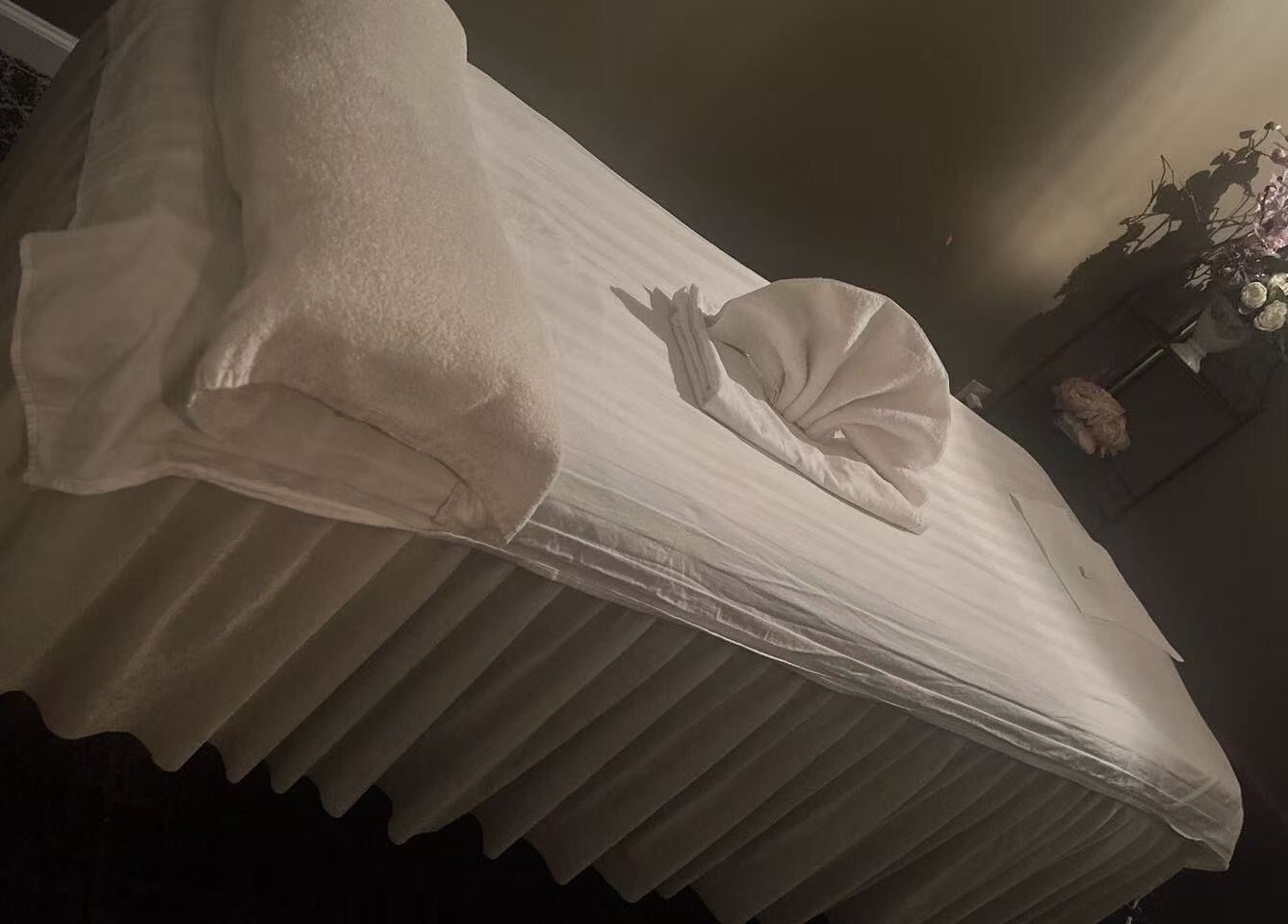 Cozy massage table at Relax Massage in Douglasville, Georgia, US, adorned with flowers for a soothing atmosphere.