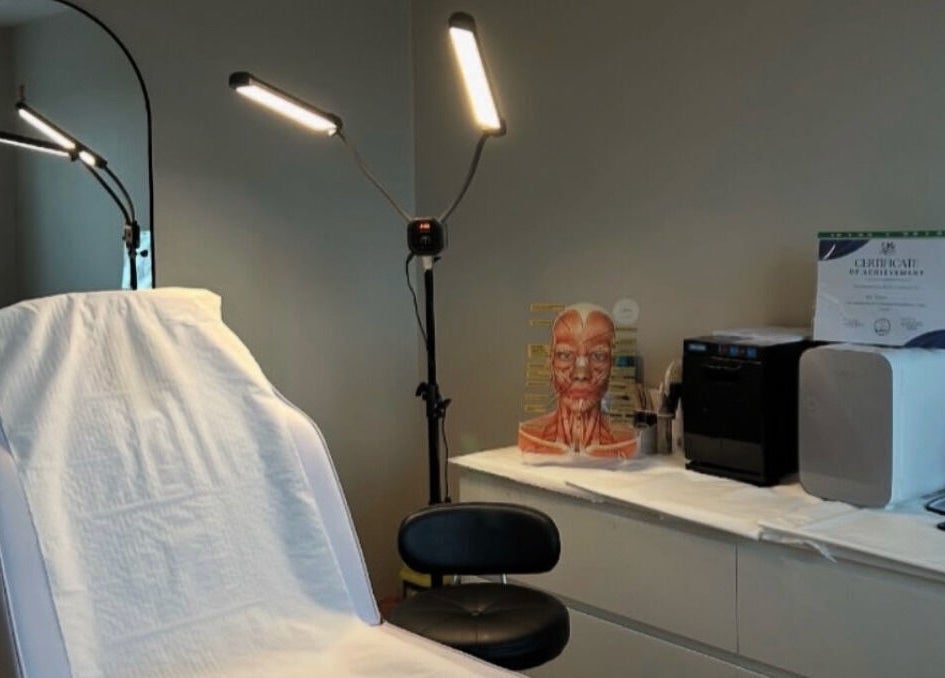 Modern treatment room at The Beauty Bar Swansea, Llansamlet, Wales, GB, with chair, mirror, and lighting.