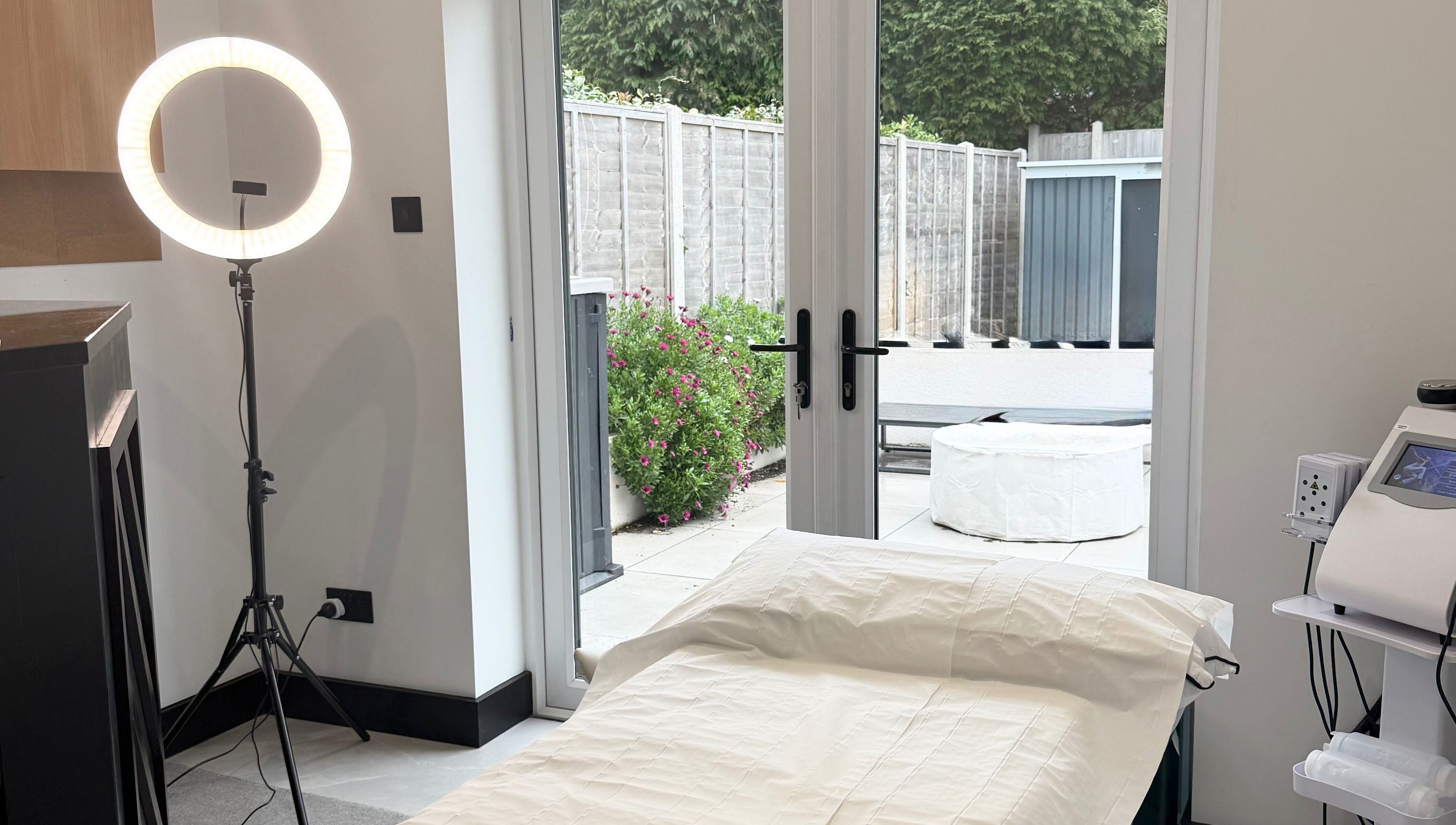 Relaxing treatment room at Secret Bodies by Anna, Poole, England, GB with outdoor view and wellness equipment.