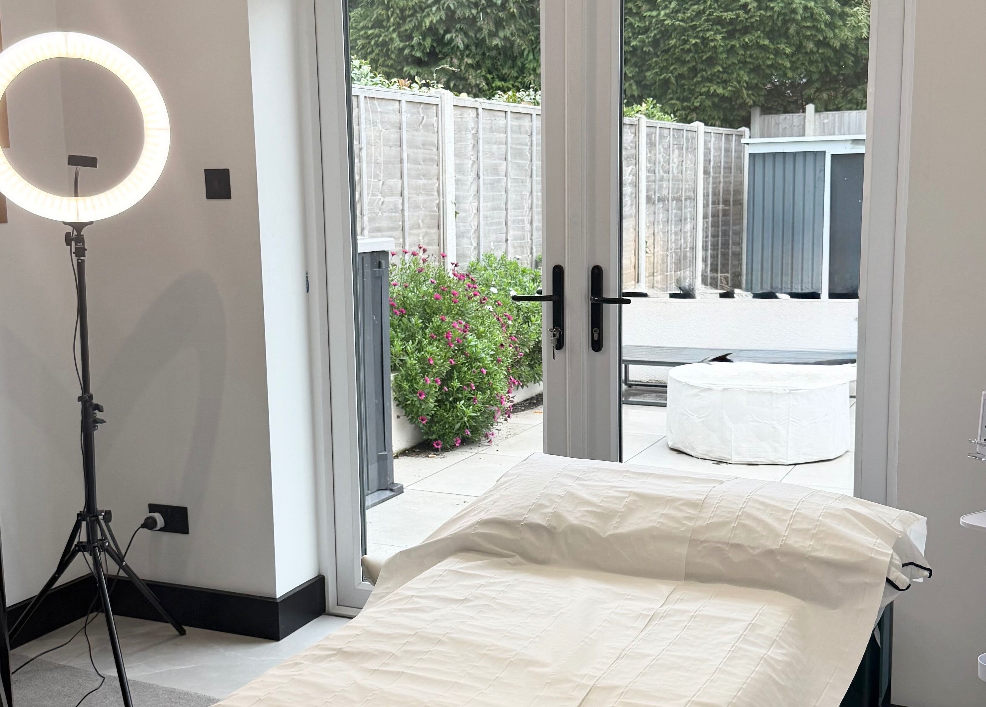 Relaxing treatment room at Secret Bodies by Anna, Poole, England, GB with outdoor view and wellness equipment.