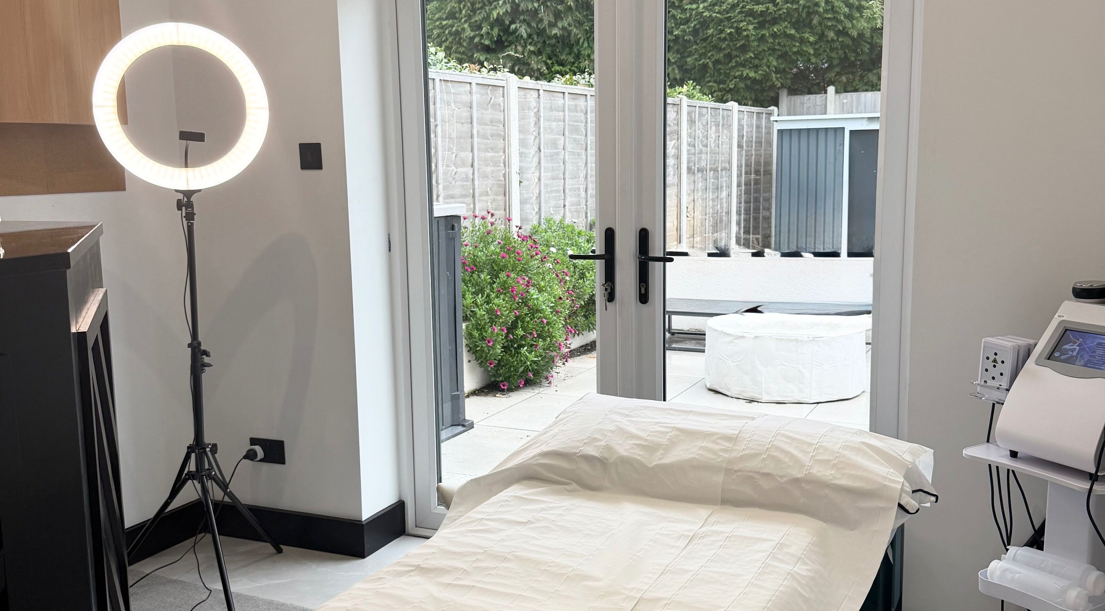 Relaxing treatment room at Secret Bodies by Anna, Poole, England, GB with outdoor view and wellness equipment.