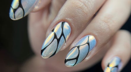 Elegant iridescent nails with black abstract lines at Tini Nails, Buenos Aires, Ciudad Autónoma De Buenos Aires, AR.