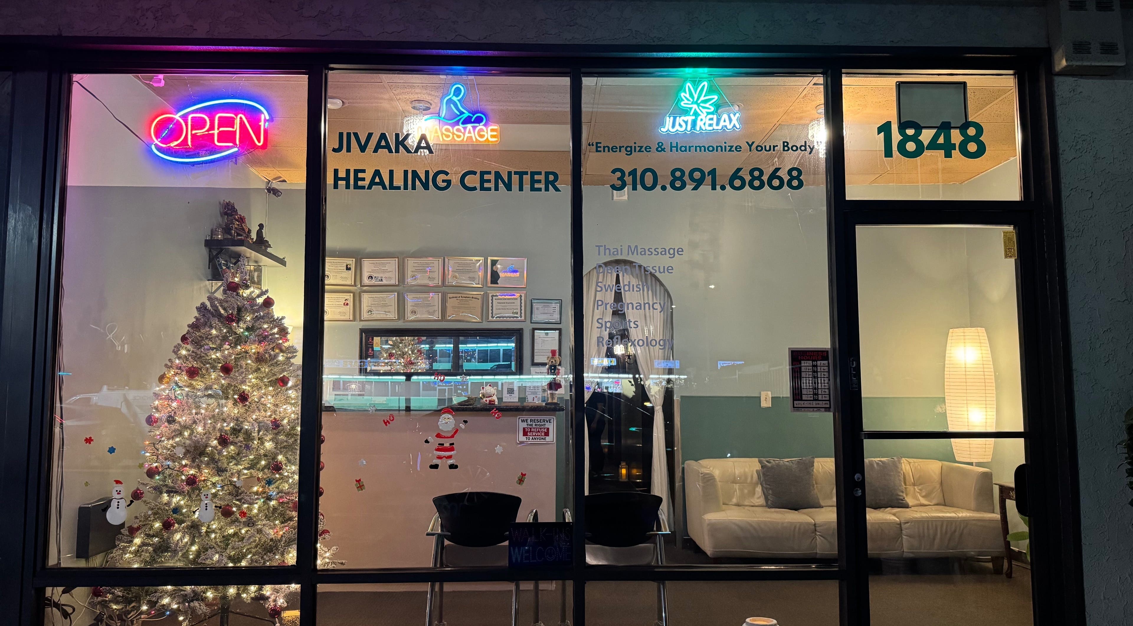 Front view of Jivaka Massage & Wellness in Lomita, CA featuring festive decor and glowing neon signs.