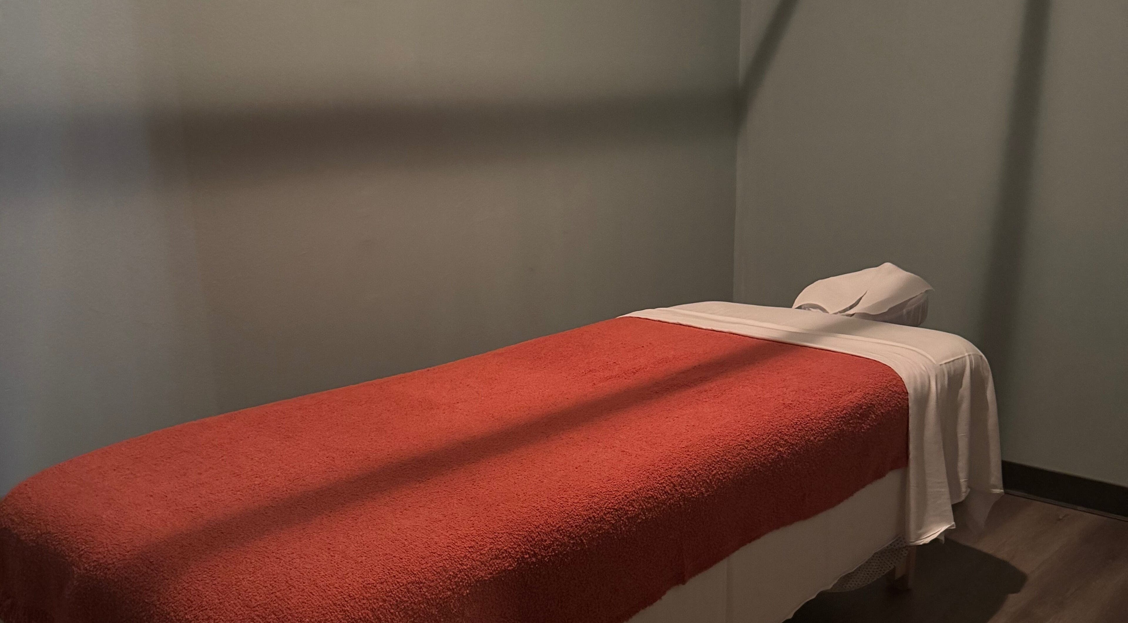 Cozy massage room at Jivaka Massage & Wellness in Lomita, California, US with a warm, inviting ambiance.