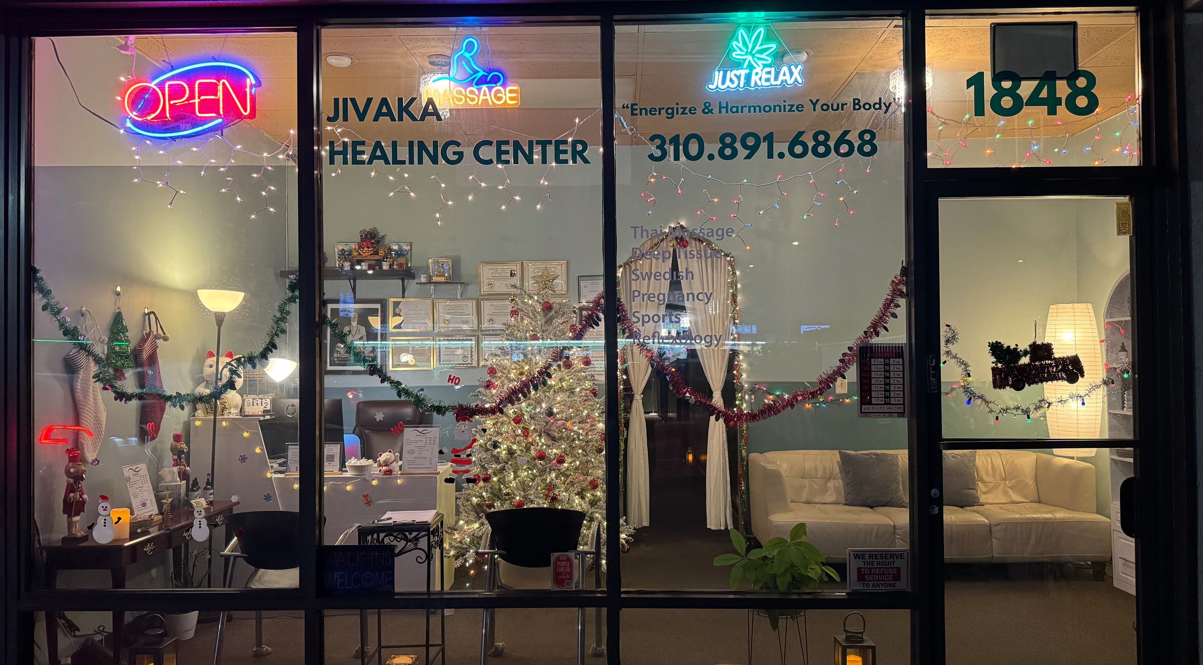 Jivaka Massage & Wellness festive front in Lomita, California, US, decorated with lights and holiday decor.