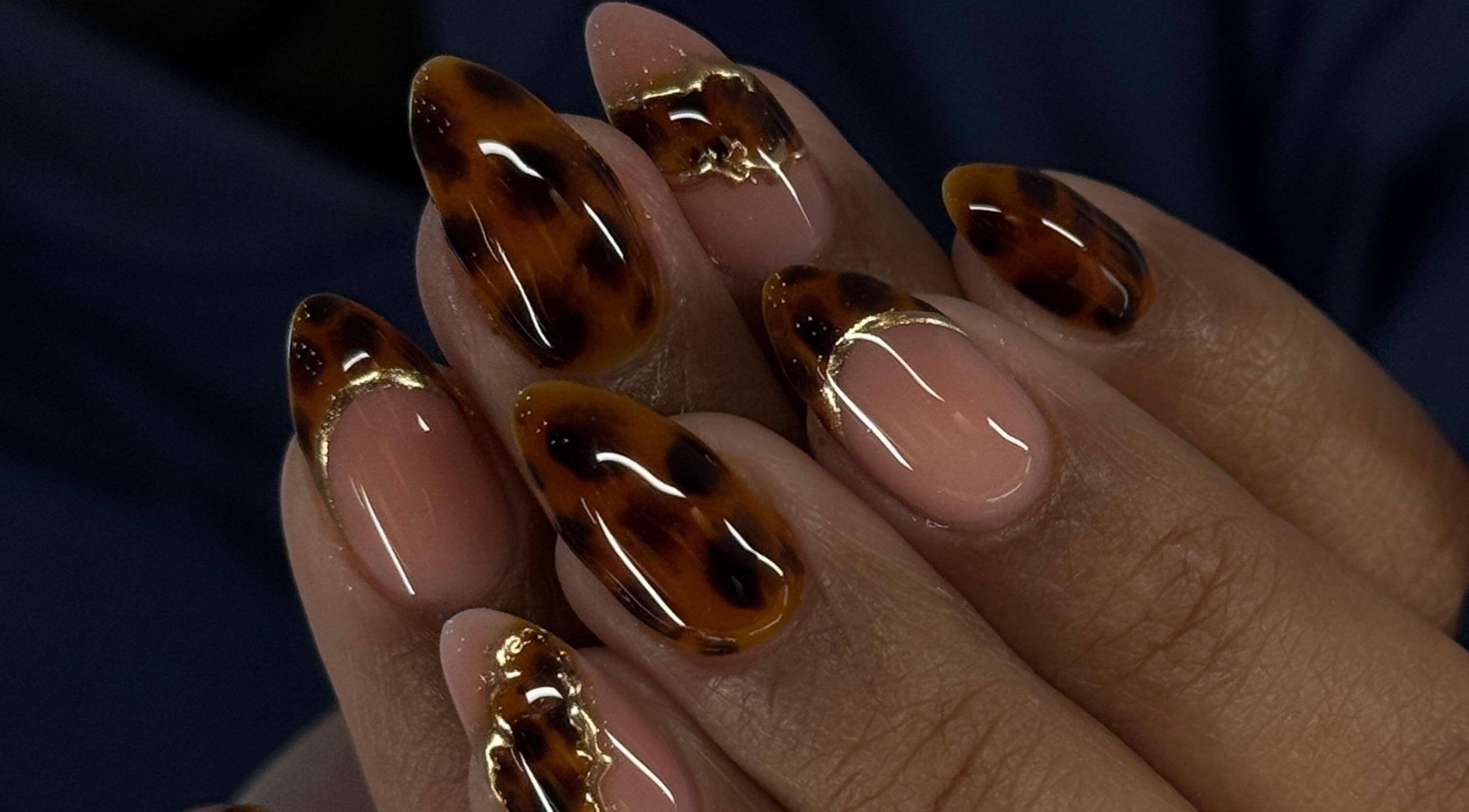 Stylish leopard-patterned nails at Ampola Nail Studio, Melbourne, Victoria, AU, showcasing modern artistry.