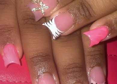 Nail art design at Urztruly Nails x Visuals in Florida, Florida, US. Features pink polish and decorative accents.