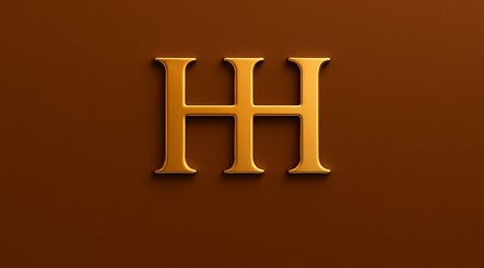 Golden HH emblem representing HH Permanent Makeup in Glendale, California, US on a rich brown background.