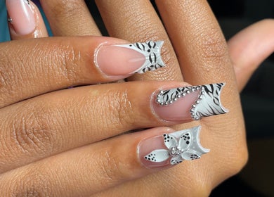 Elegant zebra pattern nails with floral design at Luxe Beautefix, Manhattan, Kansas, US.