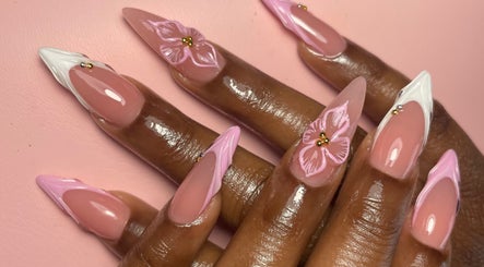 Beautiful floral nail art at Luxe Beautefix, Manhattan, Kansas, US. Detailed pink and white designs.