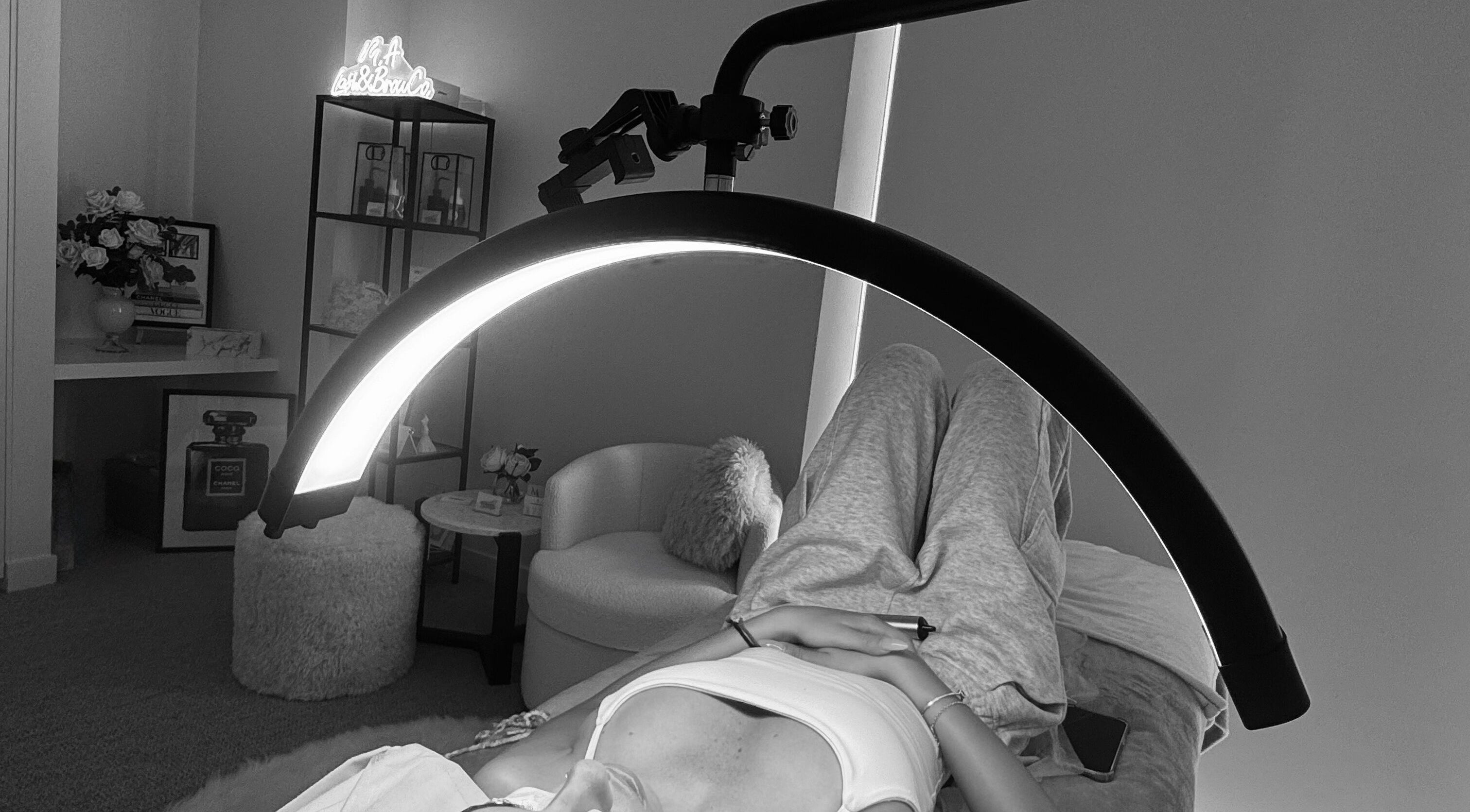 Client relaxes at M.A Lash & Brow Co., Melbourne, Victoria, AU, under stylish lighting for lash treatment.