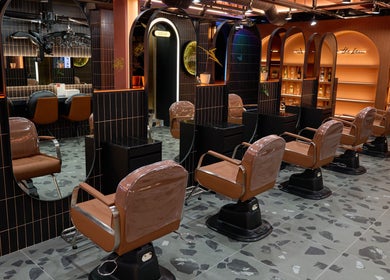 Stylish interior of Hair The Beau Myeongdong in 서울특별시 with modern salon chairs and mirrors.