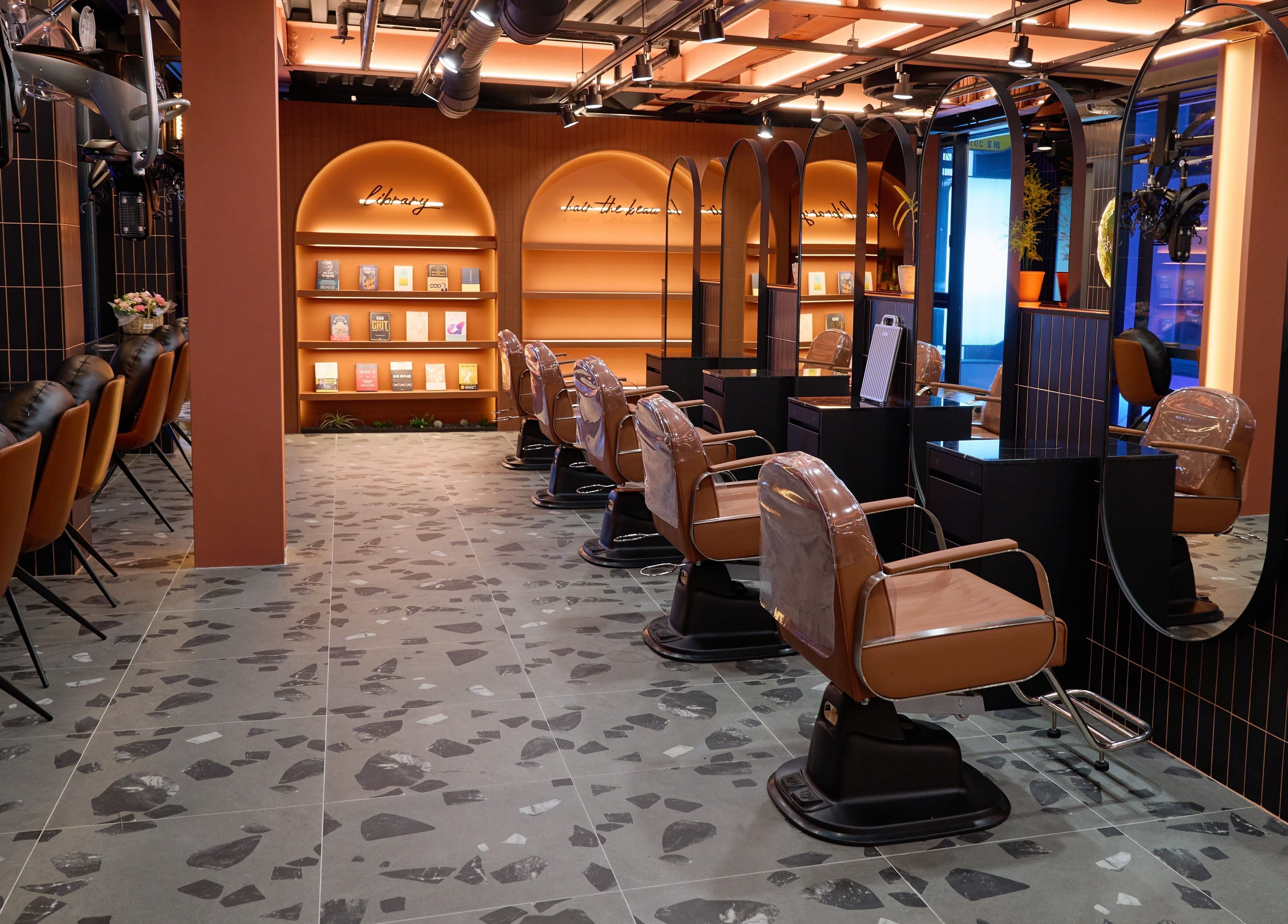 Elegant salon interior with plush chairs at Hair The Beau Myeongdong, 서울특별시, 서울특별시, KR.