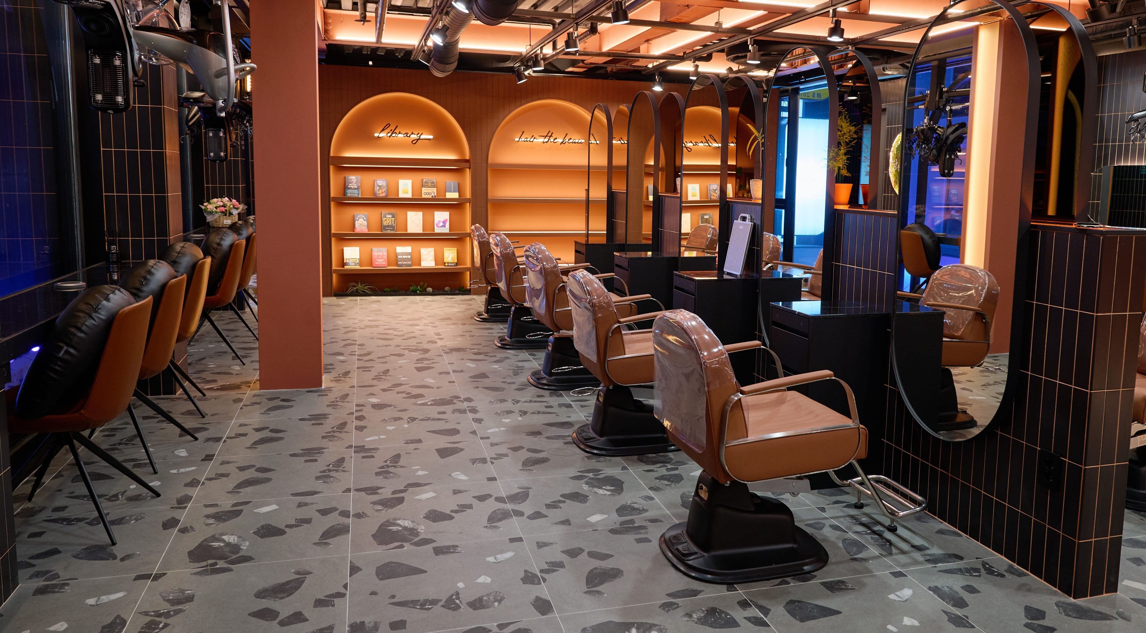 Elegant salon interior with plush chairs at Hair The Beau Myeongdong, 서울특별시, 서울특별시, KR.