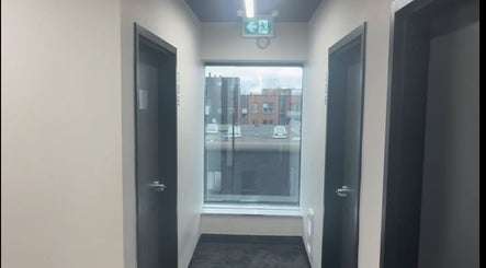 Calm hallway at TouchedByChanel, Montréal, Québec, CA with natural light from large windows.