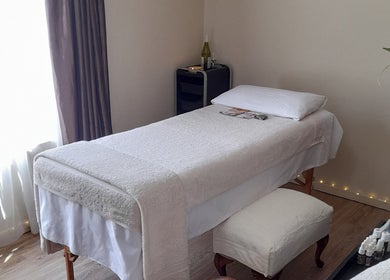 Relaxing massage room at Black Excellence Massage Studio, Pretoria, Gauteng, ZA, featuring a cozy massage bed.