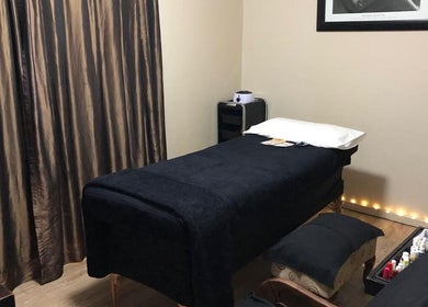 Luxurious massage room at Black Excellence Massage Studio in Pretoria, Gauteng, ZA with plush black decor.