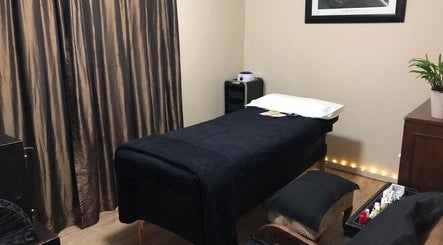 Luxurious massage room at Black Excellence Massage Studio in Pretoria, Gauteng, ZA with plush black decor.