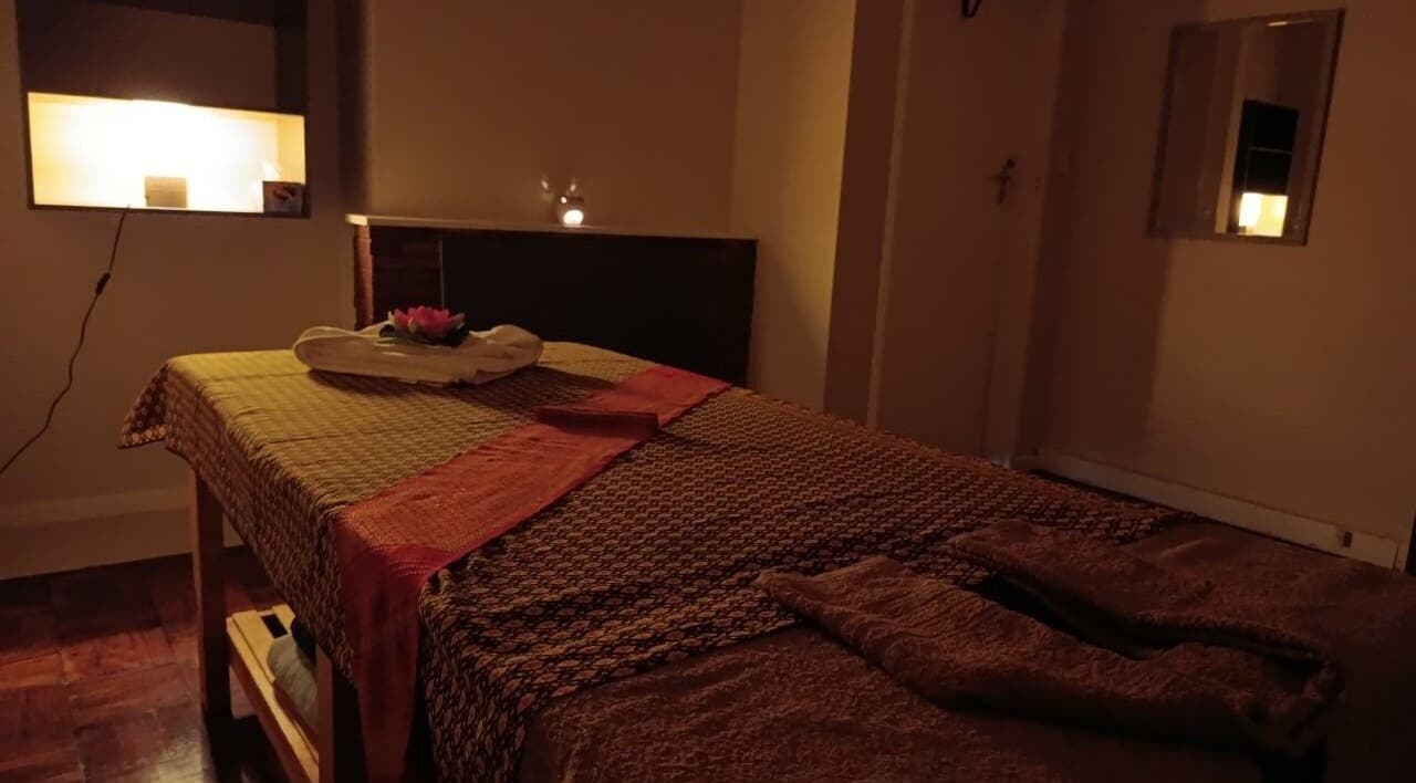 Relaxing massage room at Dok Koon Thai Massage and Wellness Spa, Cape Town, Western Cape, ZA, with warm lighting.
