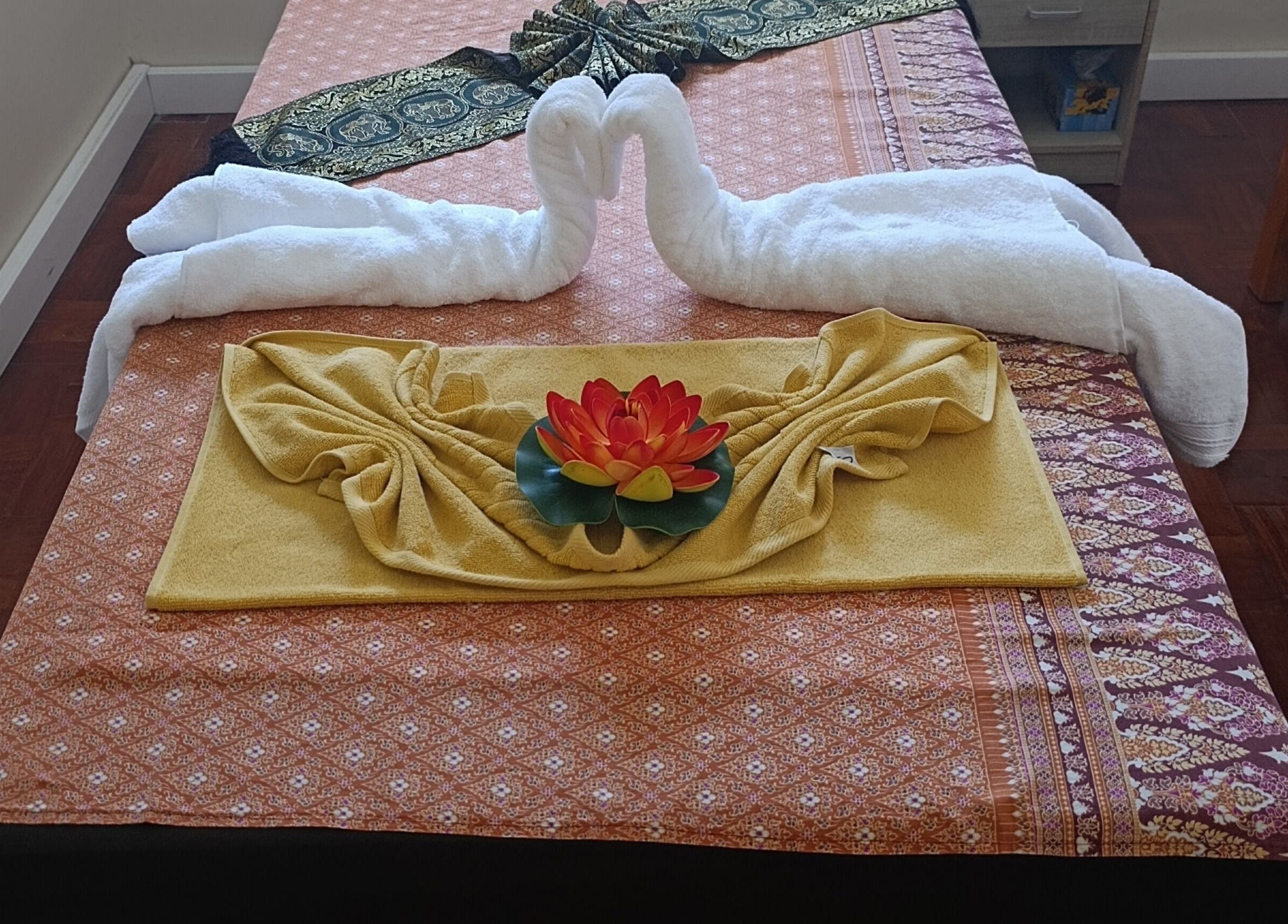 Elegant massage bed with towel swans at Dok Koon Thai Massage and Wellness Spa, Cape Town, Western Cape, ZA.
