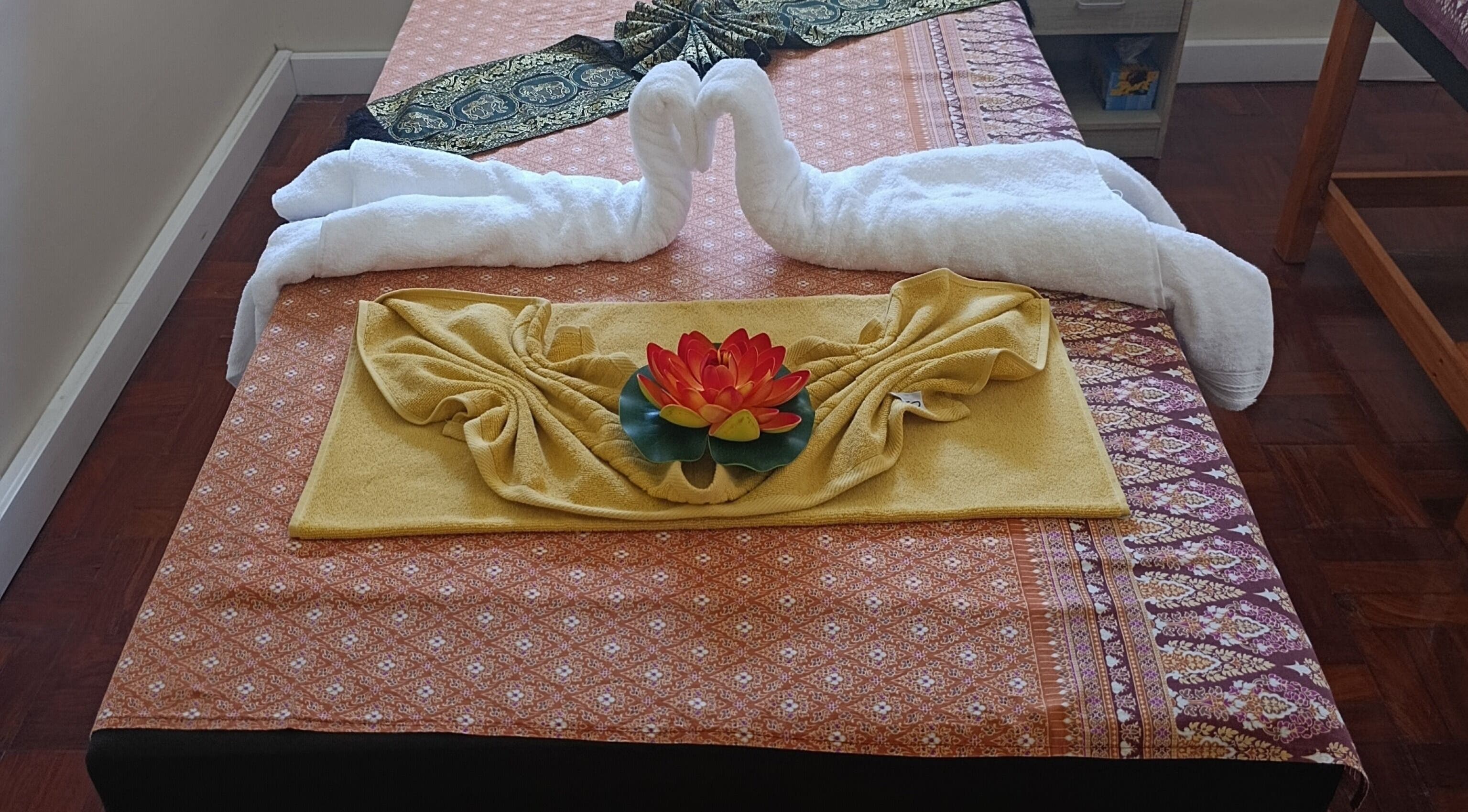Elegant massage bed with towel swans at Dok Koon Thai Massage and Wellness Spa, Cape Town, Western Cape, ZA.