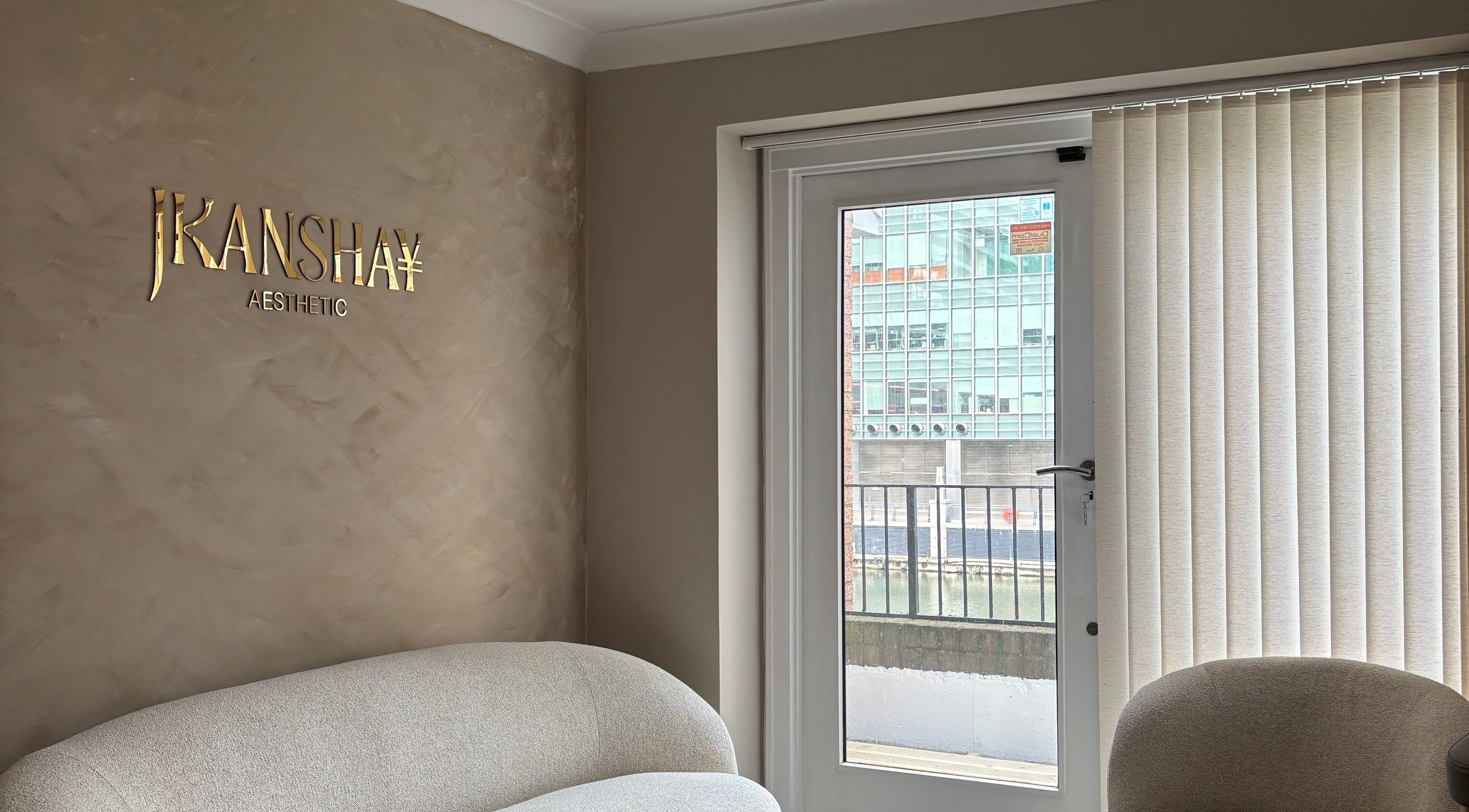 Stylish seating area at JKANSHAY AESTHETIC CLINIC, London, England, GB with cozy sofa and modern decor.