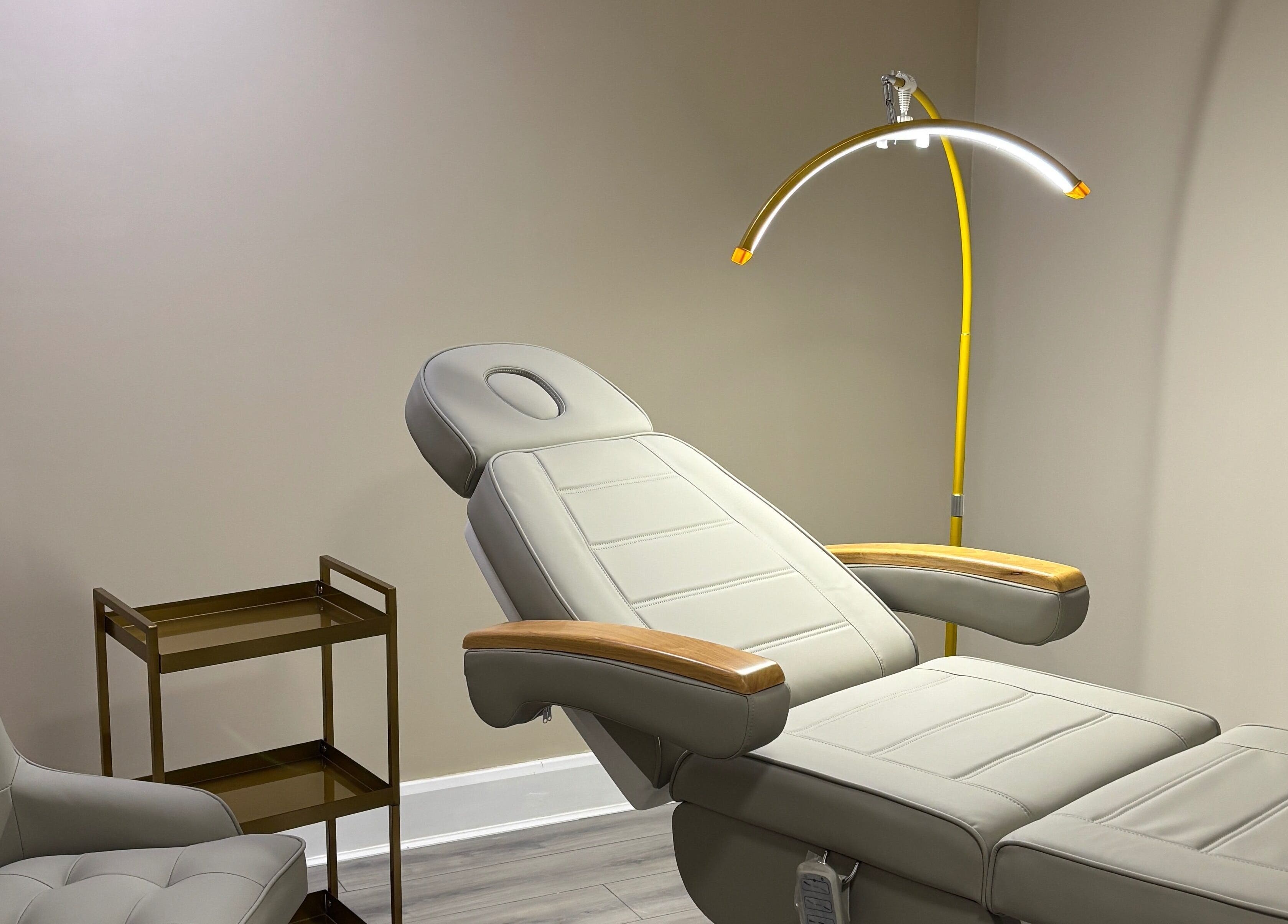 Calm treatment room at JKANSHAY AESTHETIC CLINIC, LONDON, England, GB with a reclining chair and modern design.