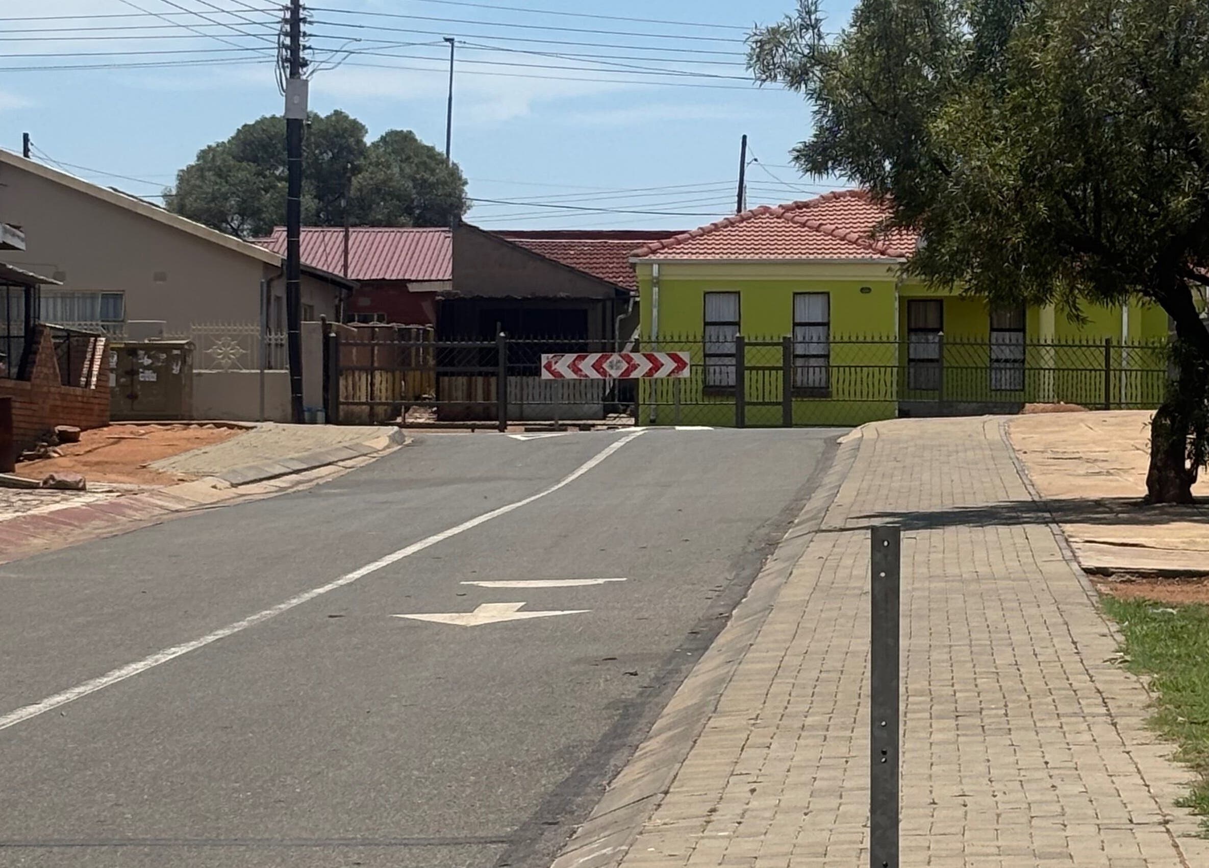 View of the street near Nailsbytshepang in Soshanguve, Gauteng, ZA, showcasing local architecture.