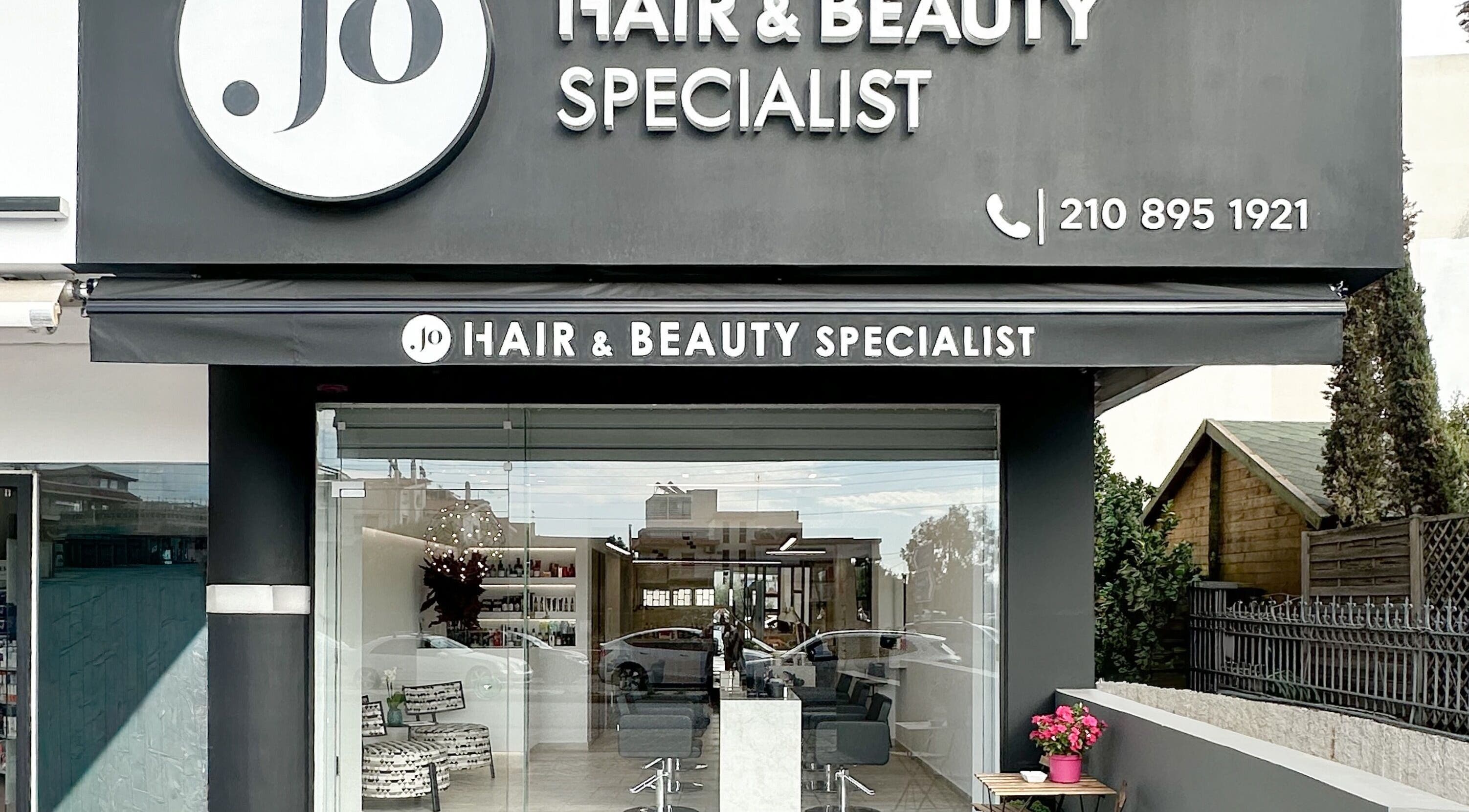 Jo Hair & Beauty entrance in Βούλα, GR, showcasing a modern and inviting salon exterior.