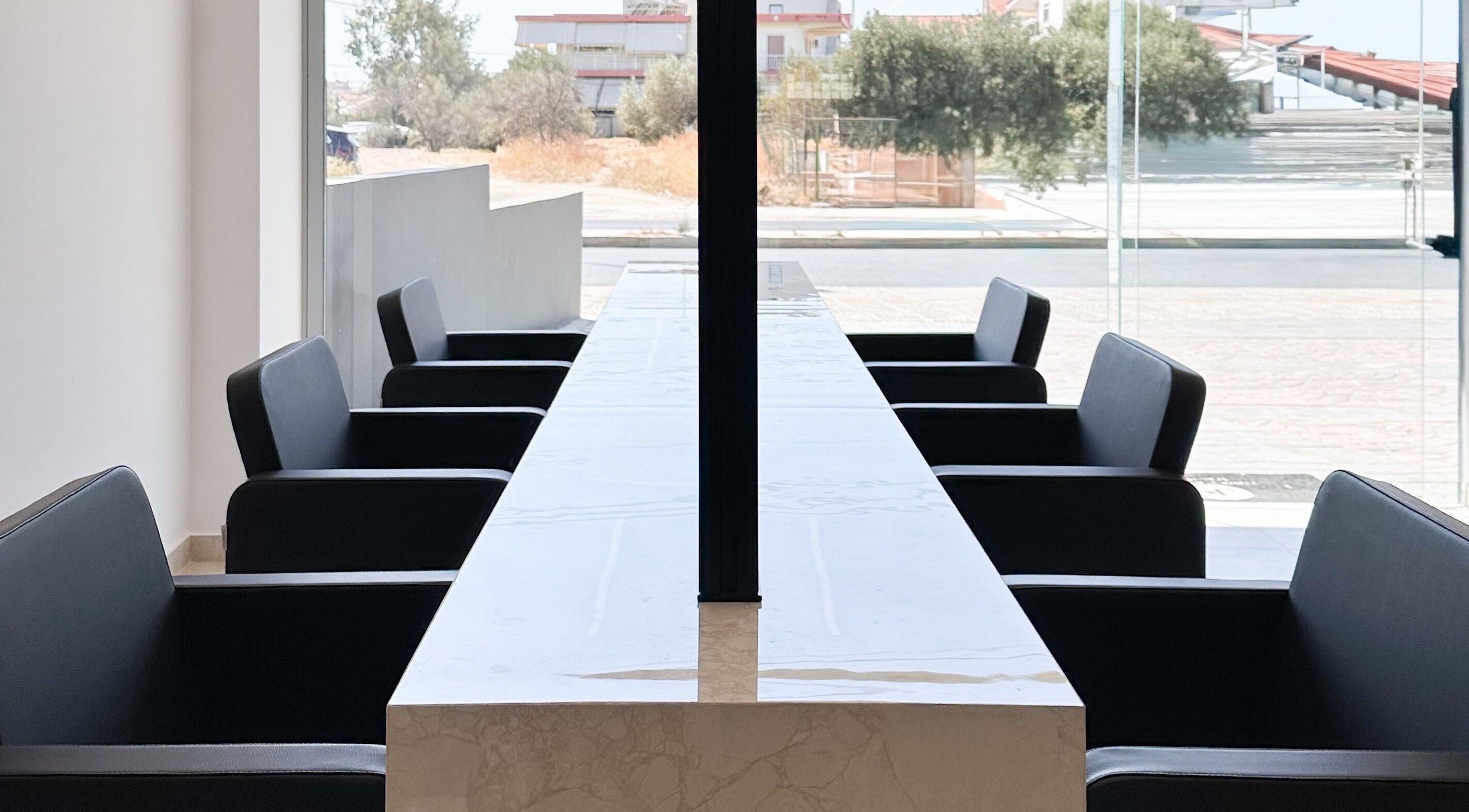 Chic modern seating area at Jo Hair & Beauty in Βούλα, GR with natural light and sleek design.