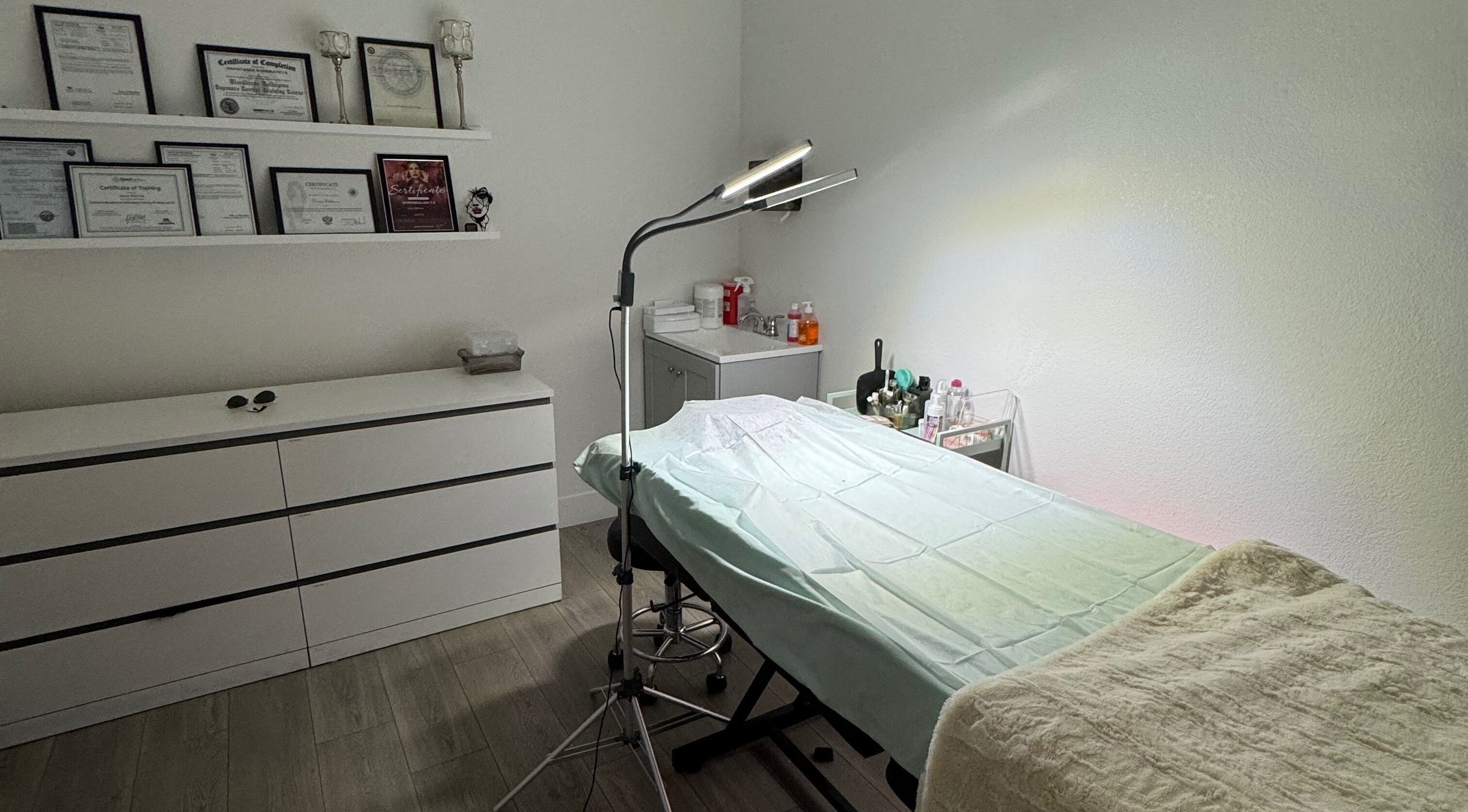 Treatment room at Daria Elkhova Beauty Studio, Rocklin, California, US, featuring cozy setting and beauty certificates.