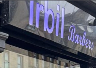 Irbil Barbers & Amani 6-Hairdresser's sign in Bradford, England, GB with purple lettering.
