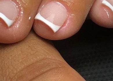 French pedicure at Happy Feet & Nails in Willemstad, Curaçao, CW showcasing perfectly manicured toes.