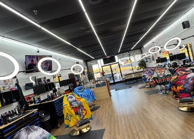 Spacious interior of Ray’s Dominican Barbershop in Roswell, Georgia, US, showcasing sleek chairs and bright lighting.