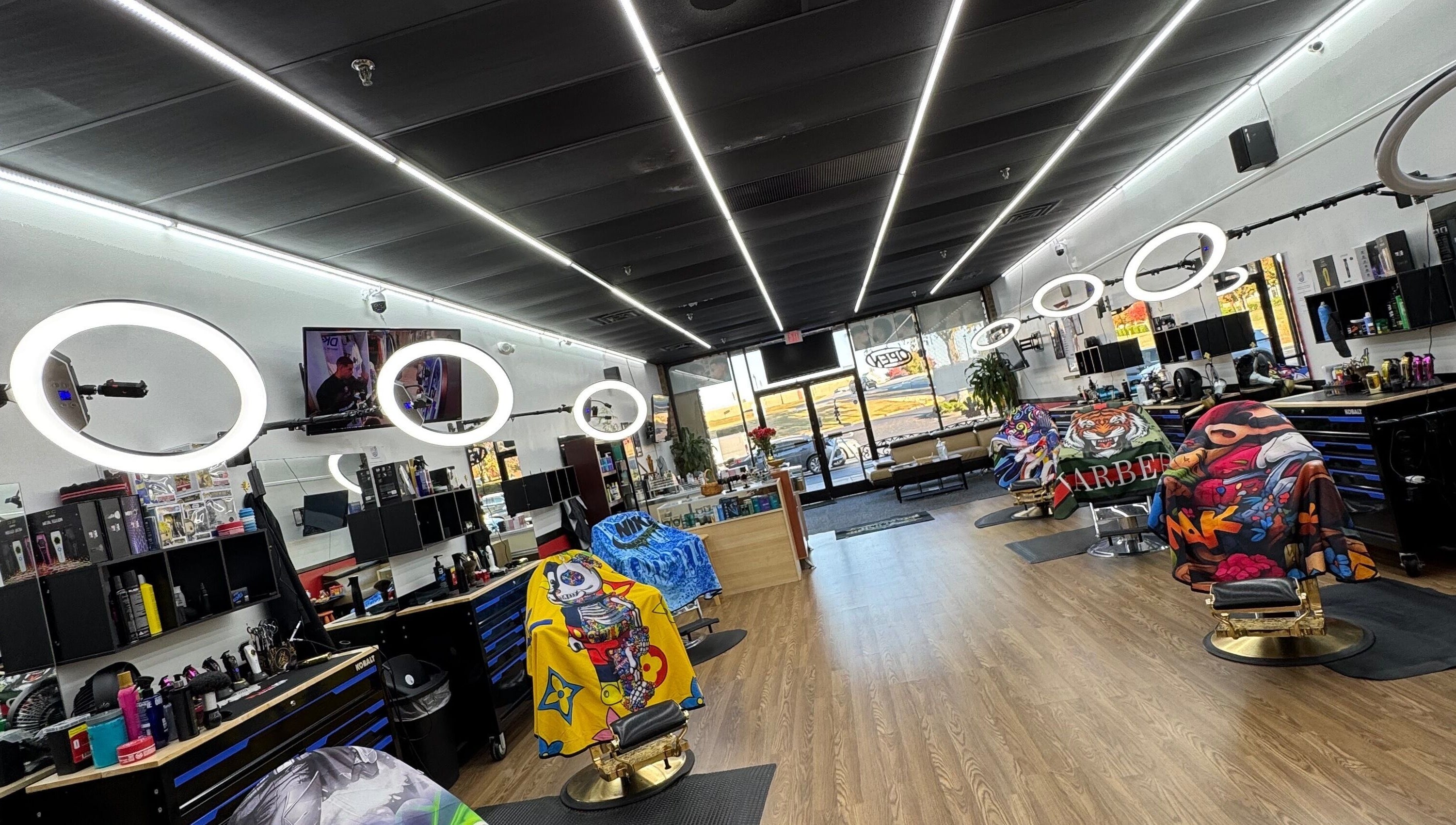 Bright interior of Ray’s Dominican Barbershop, Roswell, Georgia, US, with colorful barber chairs and modern lighting.
