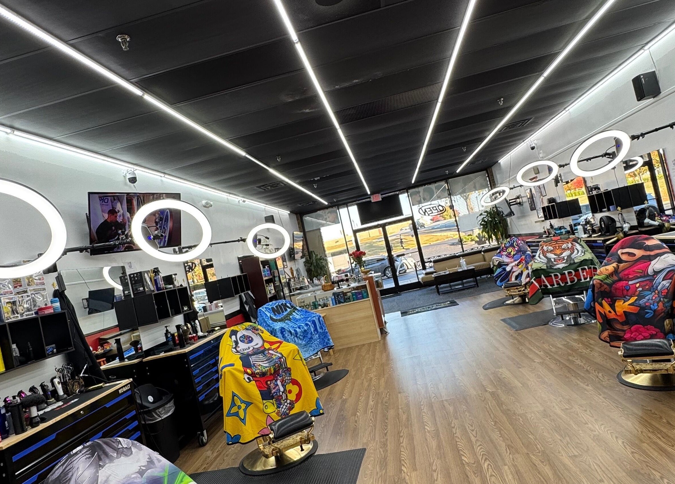 Bright interior of Ray’s Dominican Barbershop, Roswell, Georgia, US, with colorful barber chairs and modern lighting.
