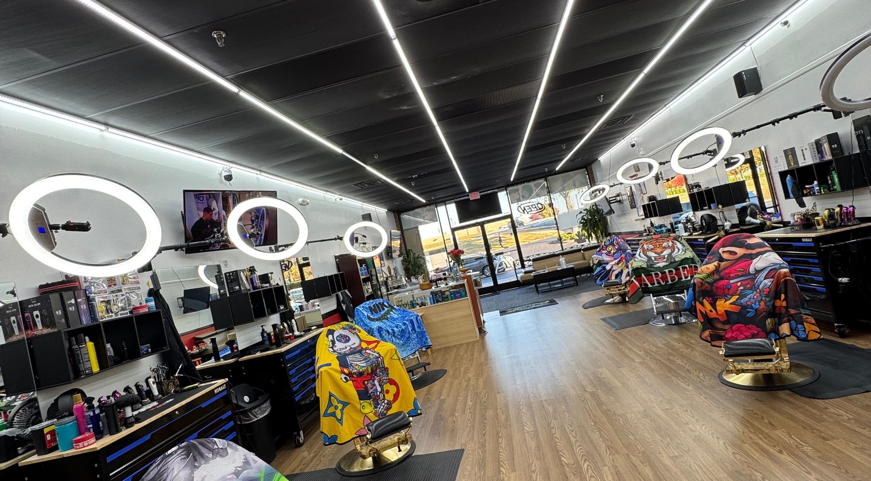 Bright interior of Ray’s Dominican Barbershop, Roswell, Georgia, US, with colorful barber chairs and modern lighting.