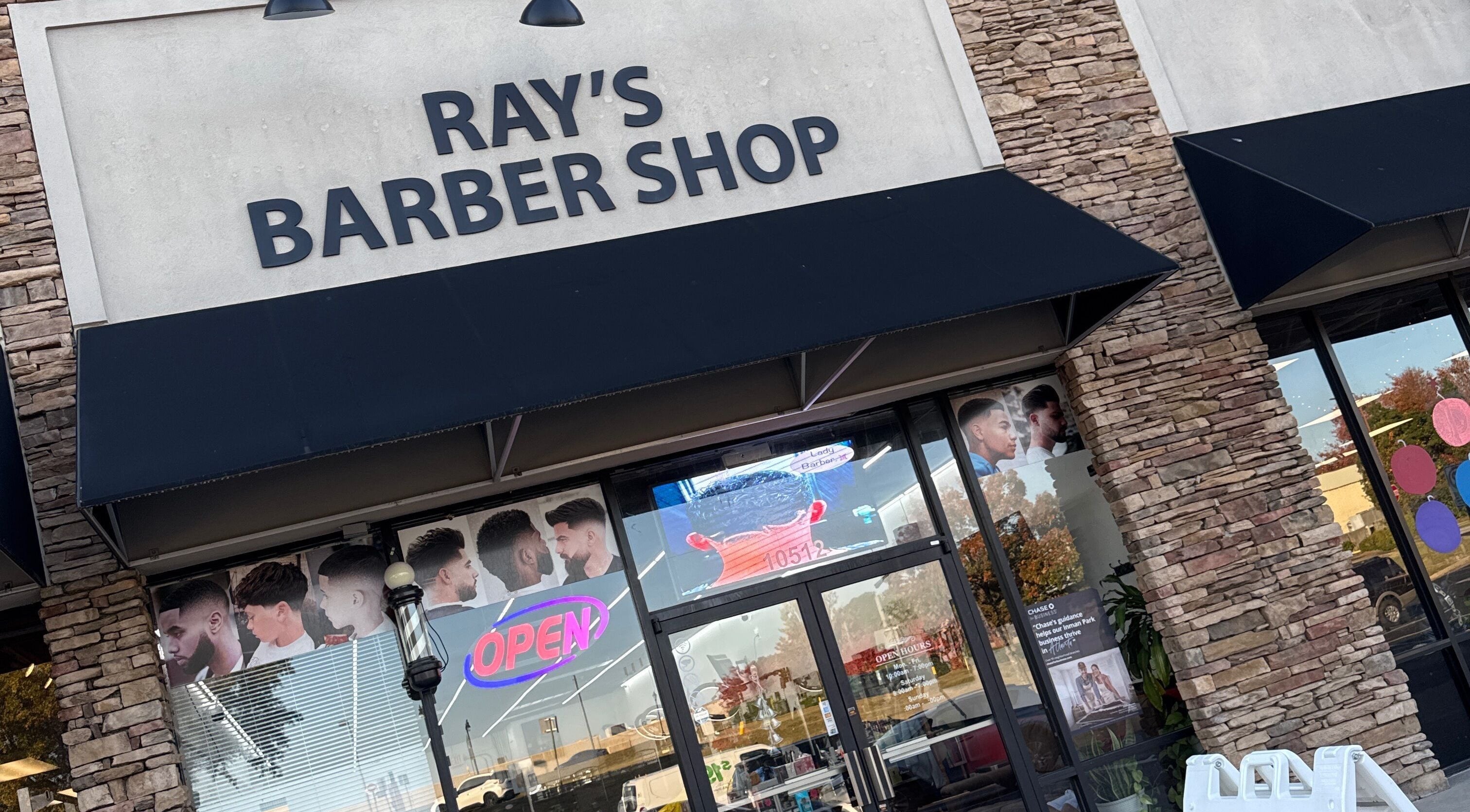 Entrance of Ray’s Dominican Barbershop in Roswell, Georgia, US with a modern design and welcoming vibe.