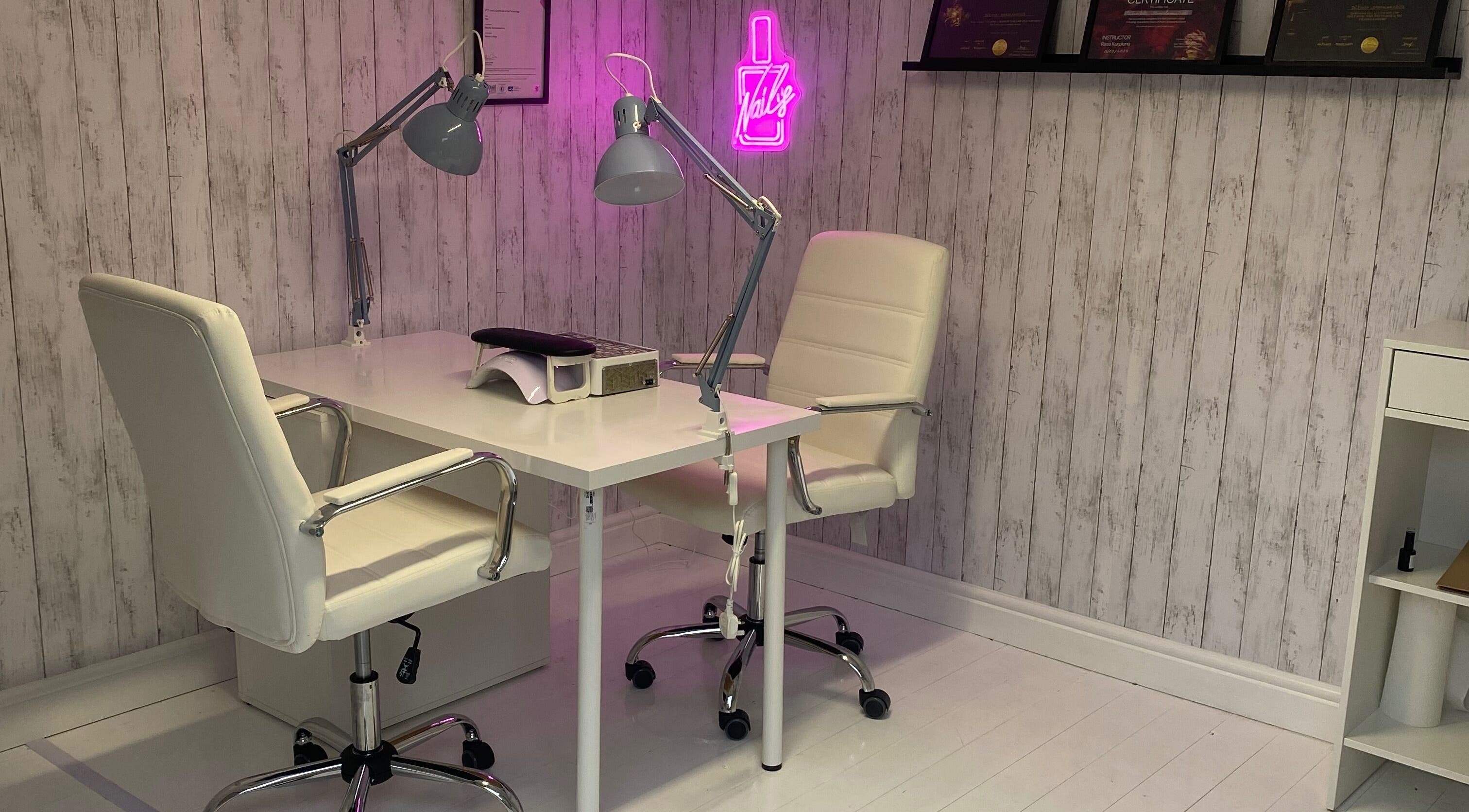 Modern nail salon desk at The Nail Haus, Boston, England. Elegant decor with certificates on display.