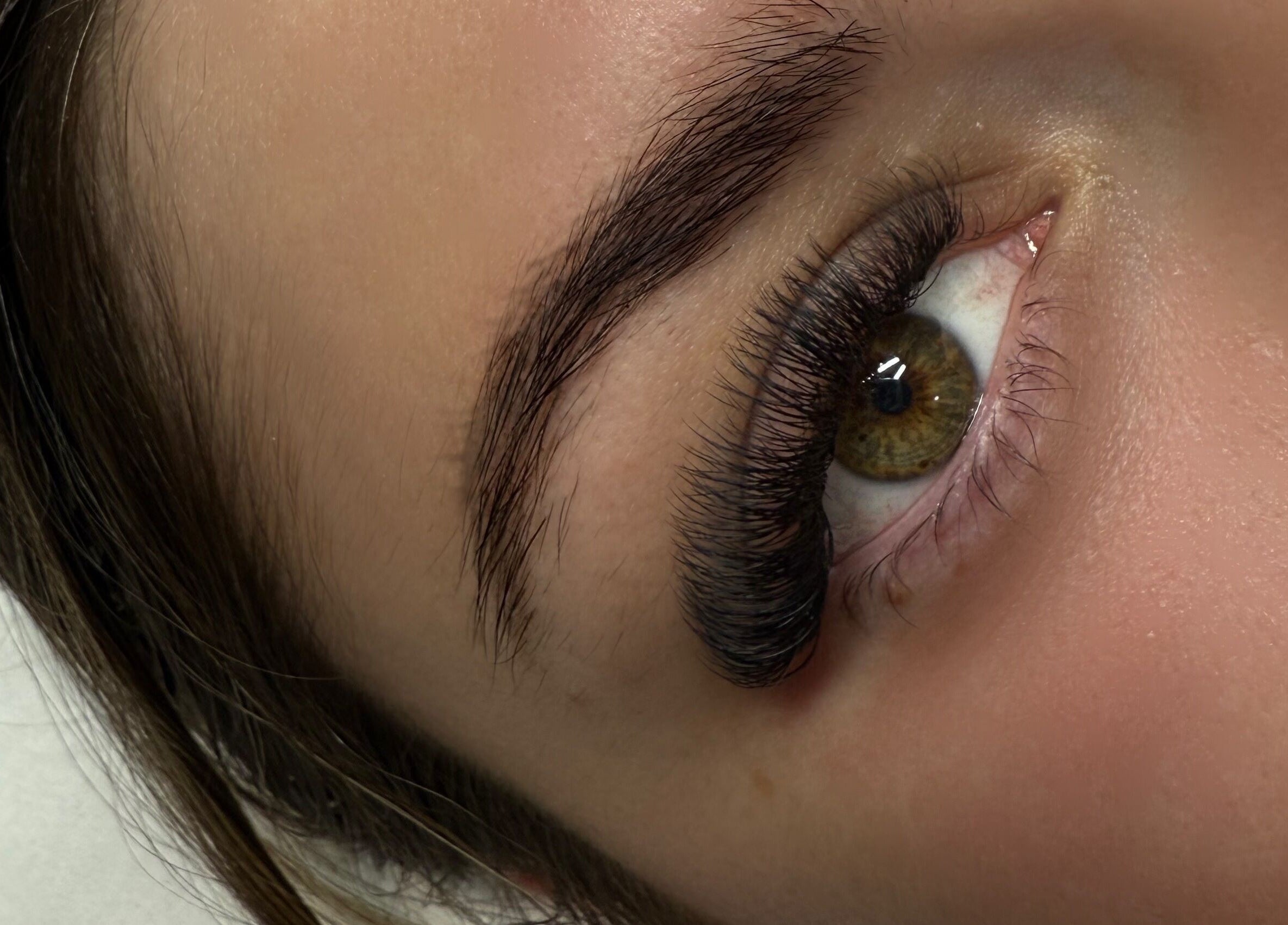 Close-up of eyelash extensions at Rayas.Beautybar, Beenleigh, Queensland, AU, showcasing volumized natural look.