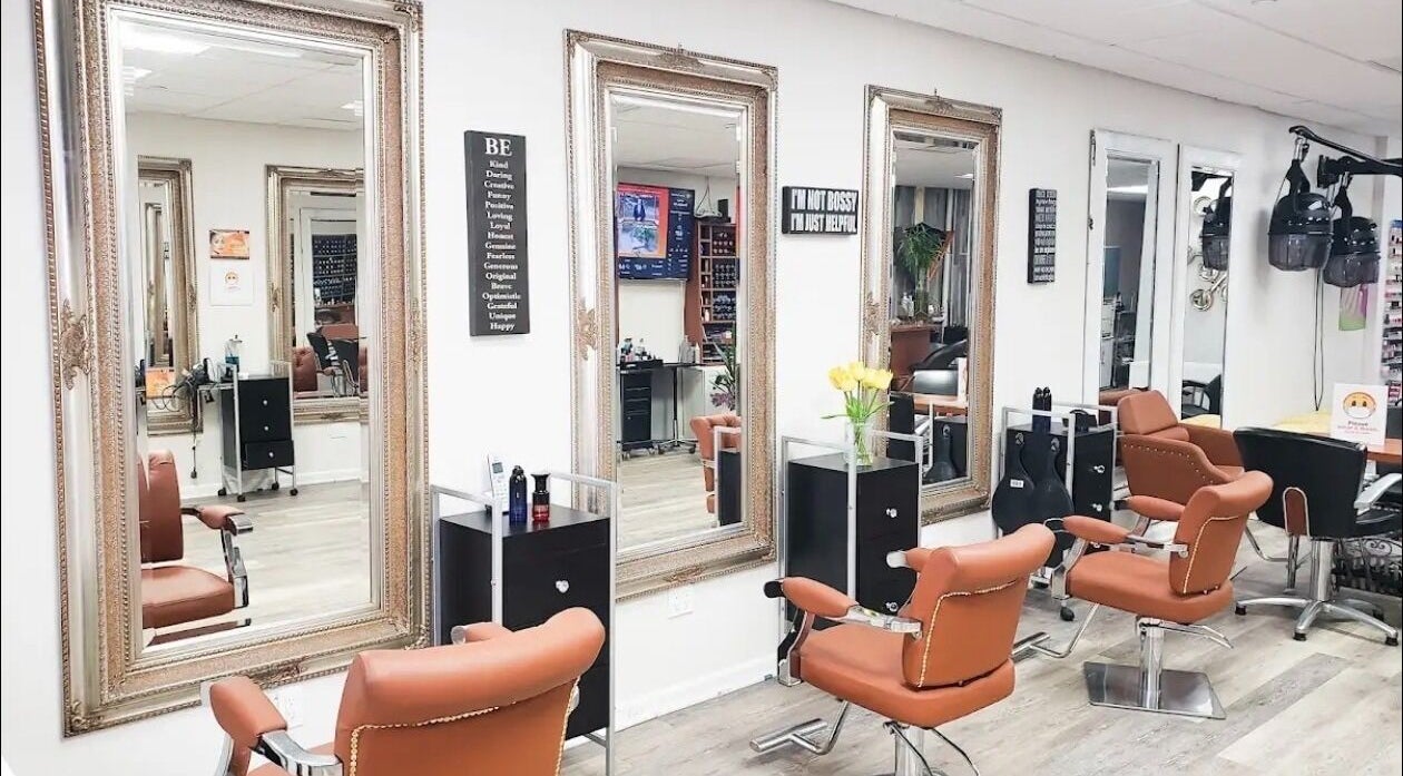 Elegant salon interior at Millie's All About You in New York, New York, US, featuring chic styling chairs and mirrors.